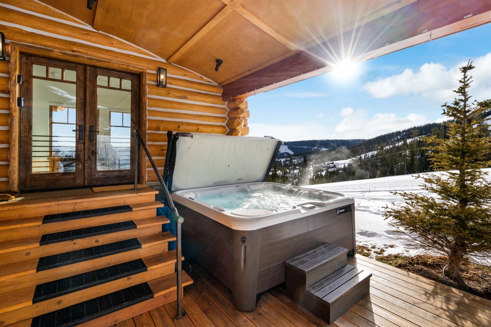 Cabin porch with hot tub.