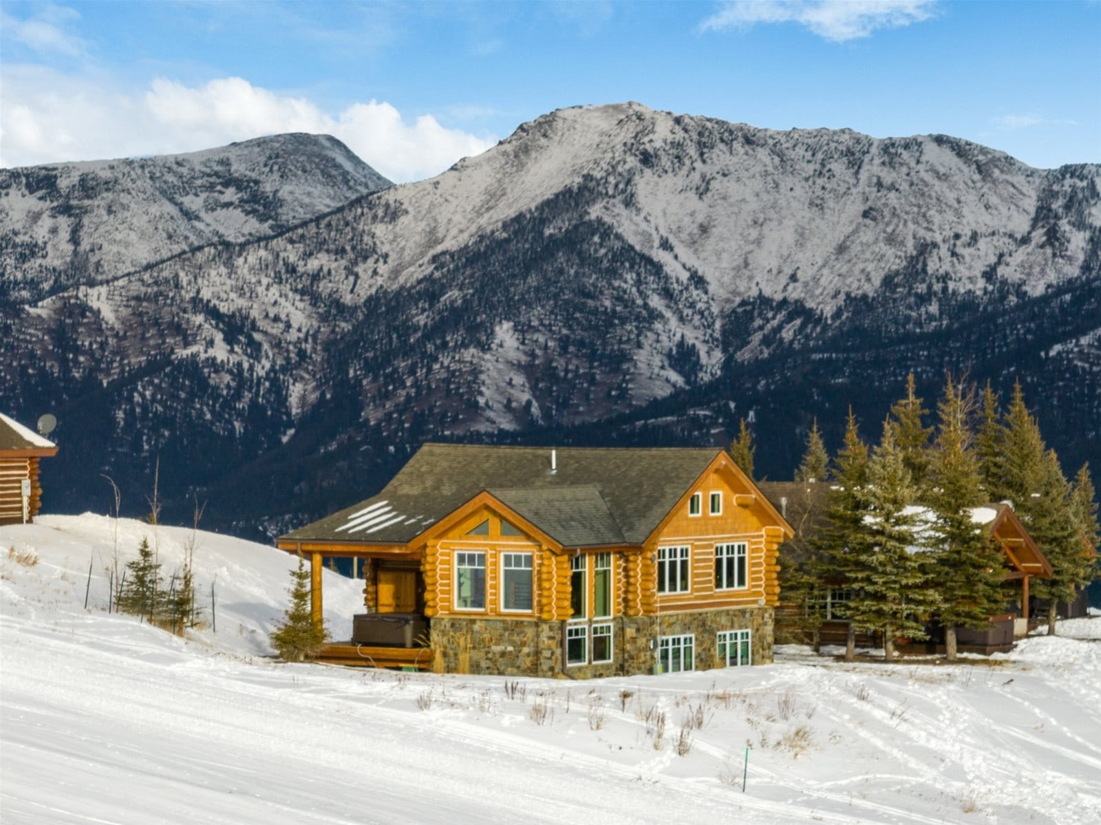 Mountain cabin in snowy landscape.