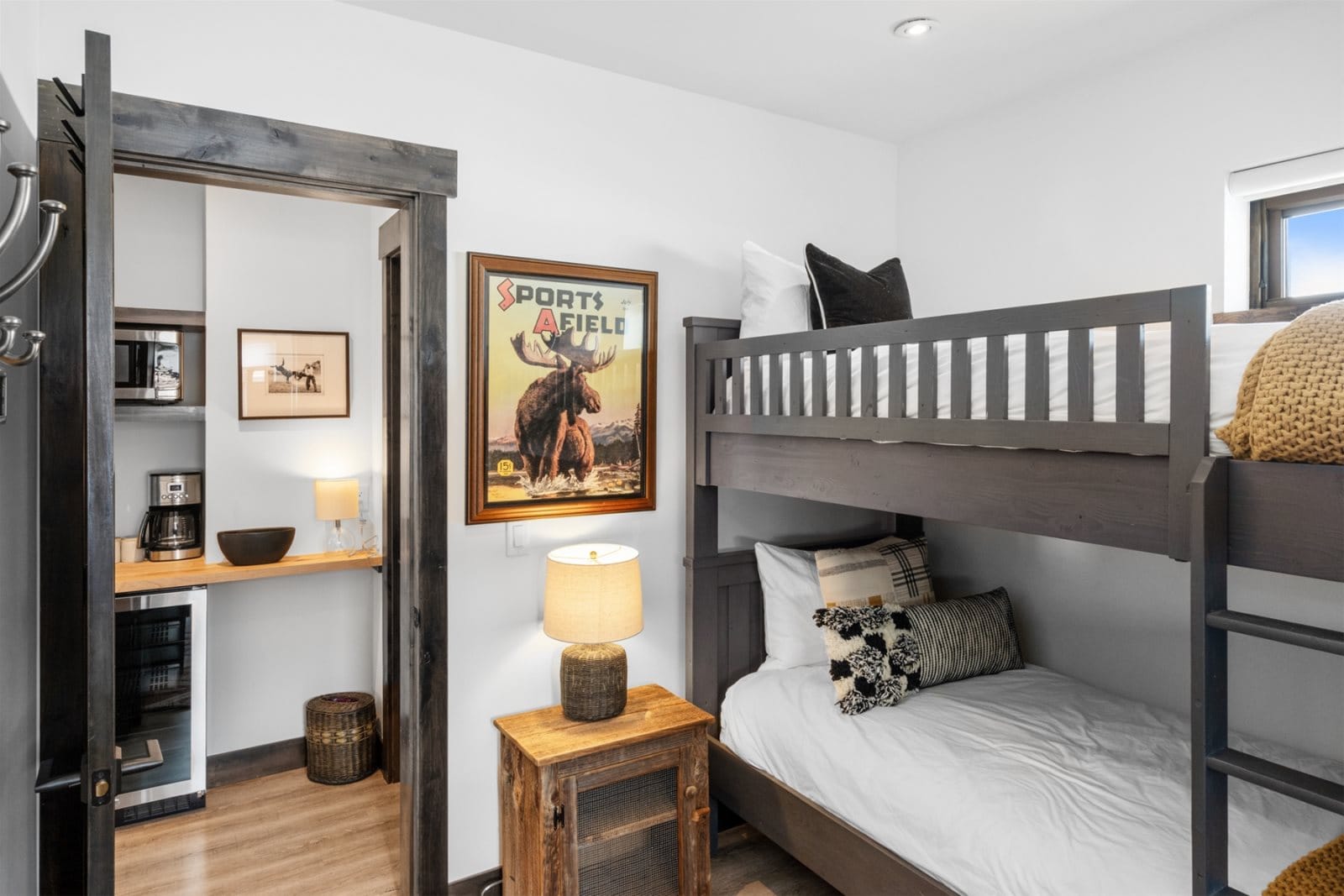 Bunk bed, poster, kitchenette, wood accents.