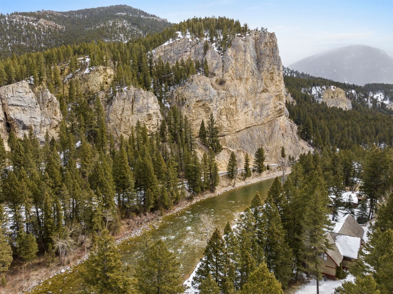 Forest, river, large rock formation.