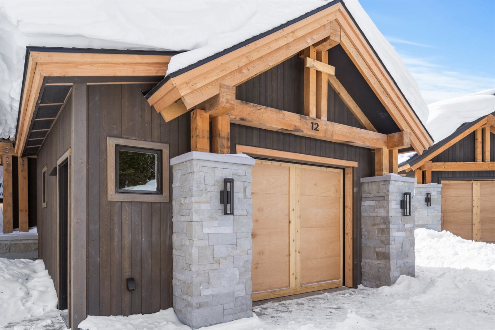 Snow-covered cabin with wooden trim.