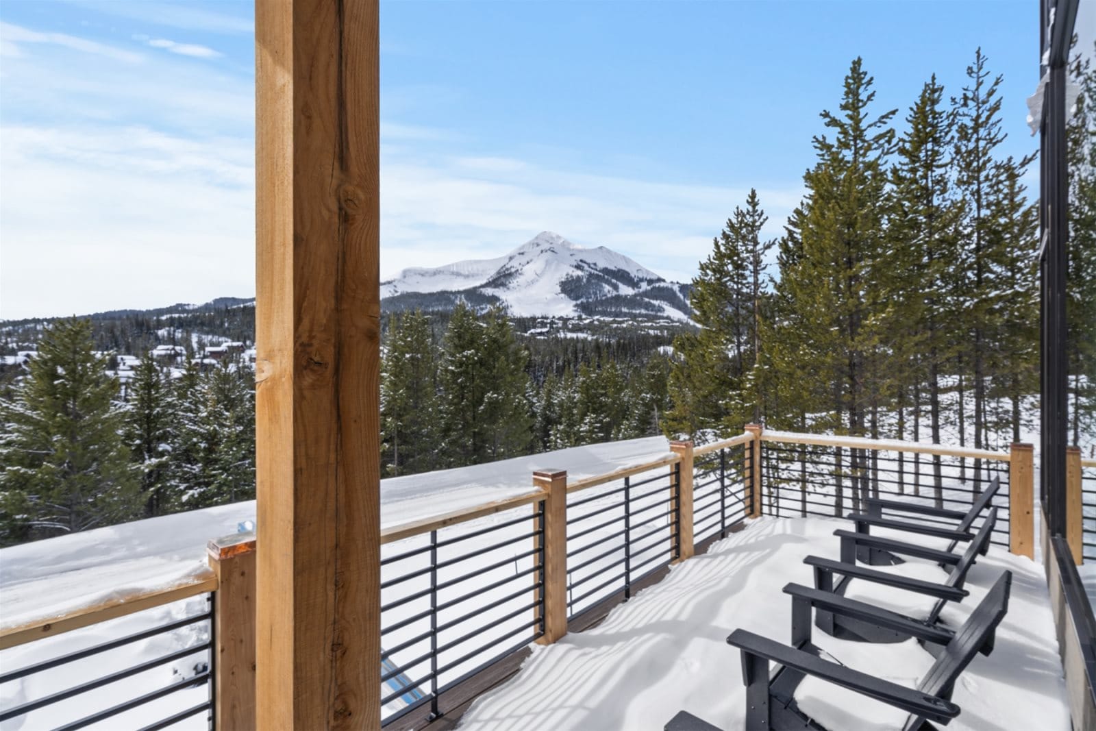 Snowy mountain view from wooden deck