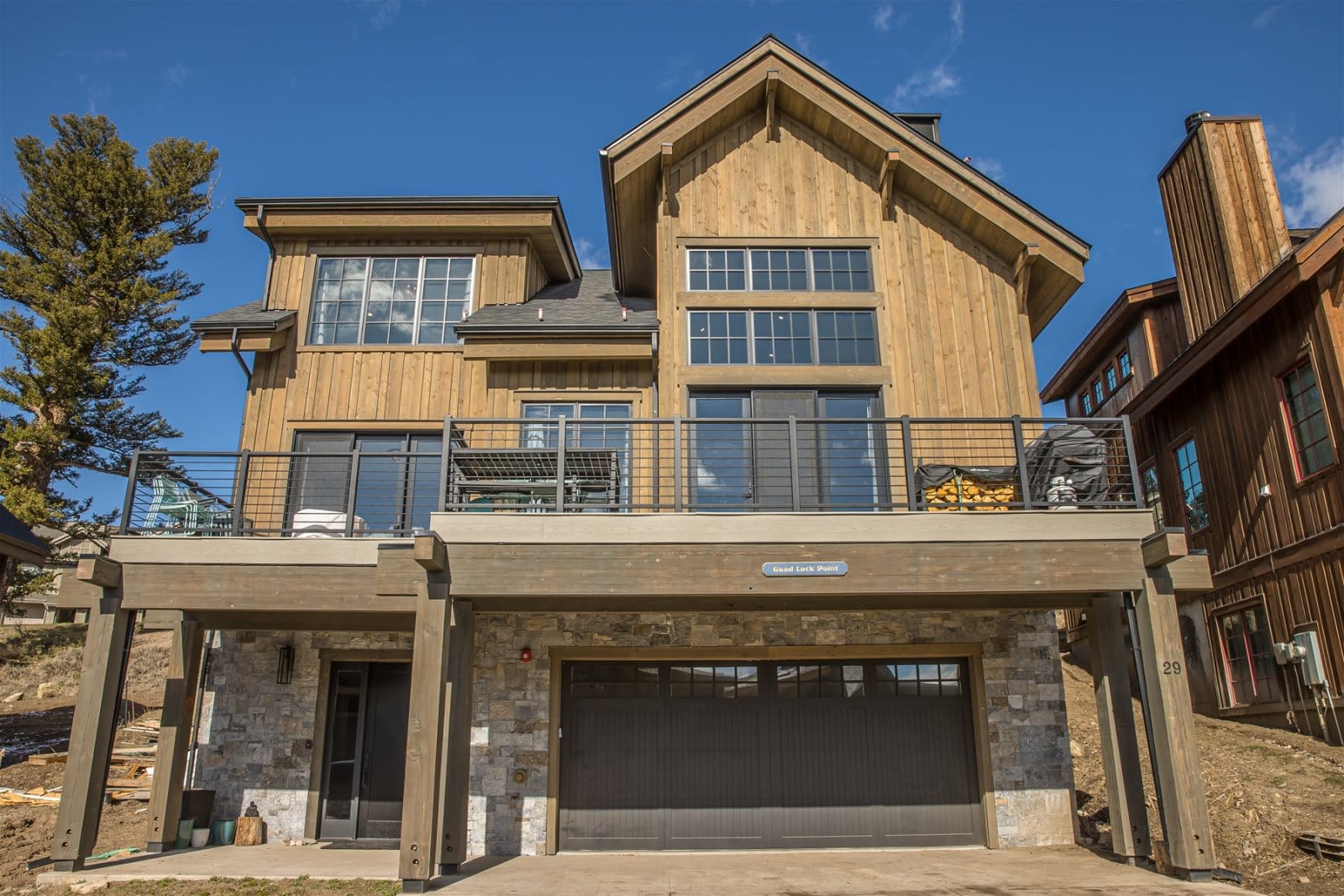 Two-story wooden house with garage.