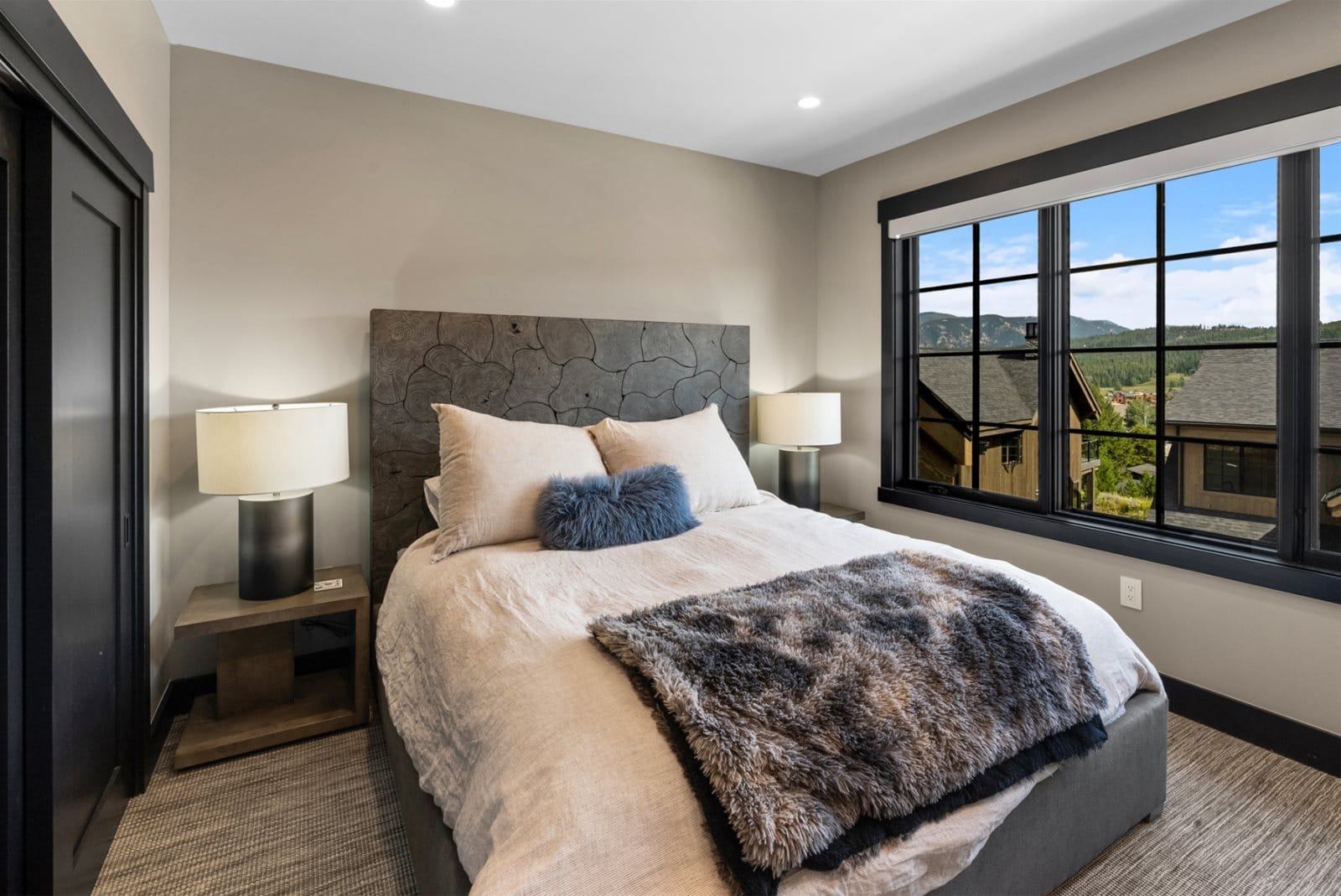 Cozy bedroom with large window.