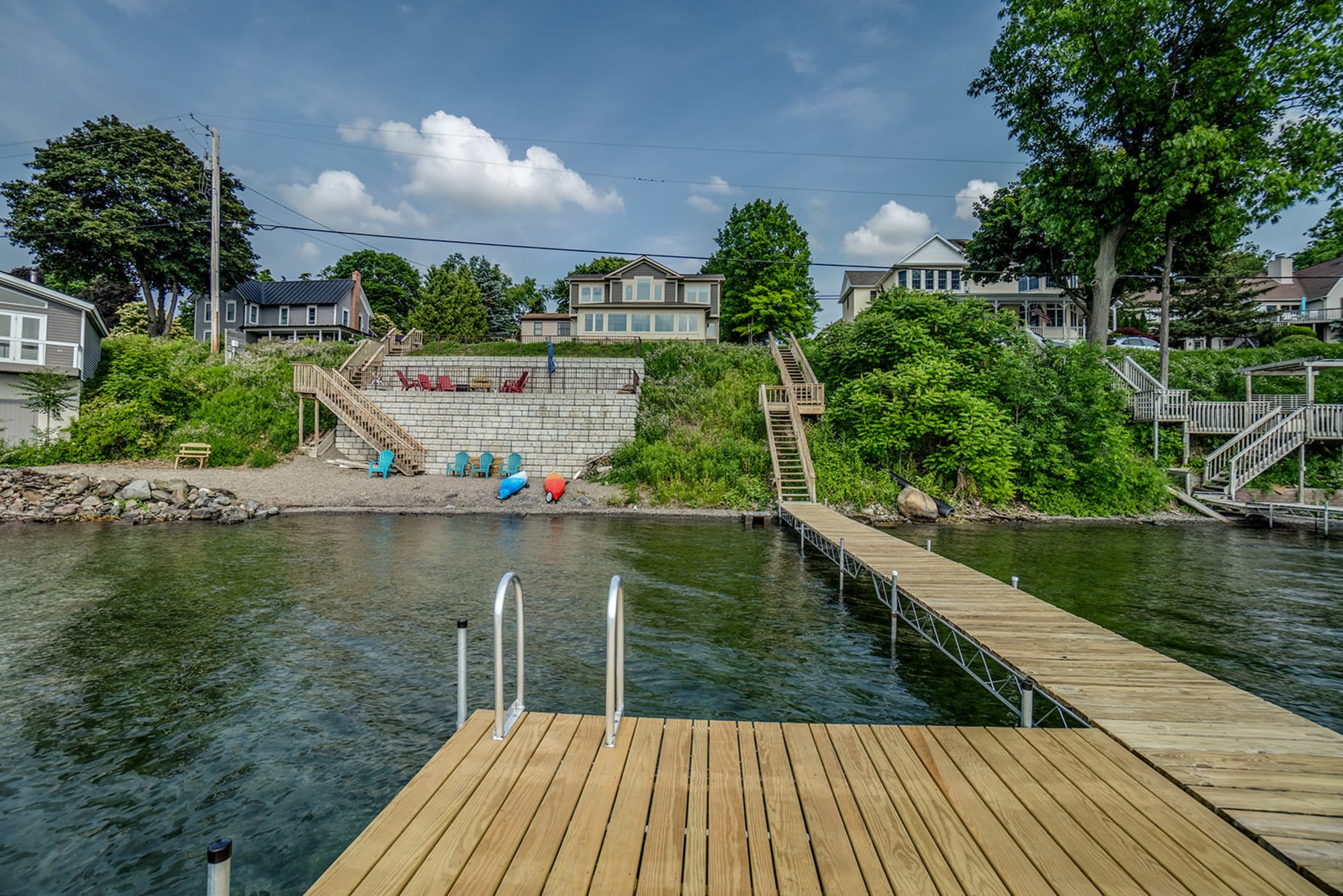 Lakeside house with dock and stairs.