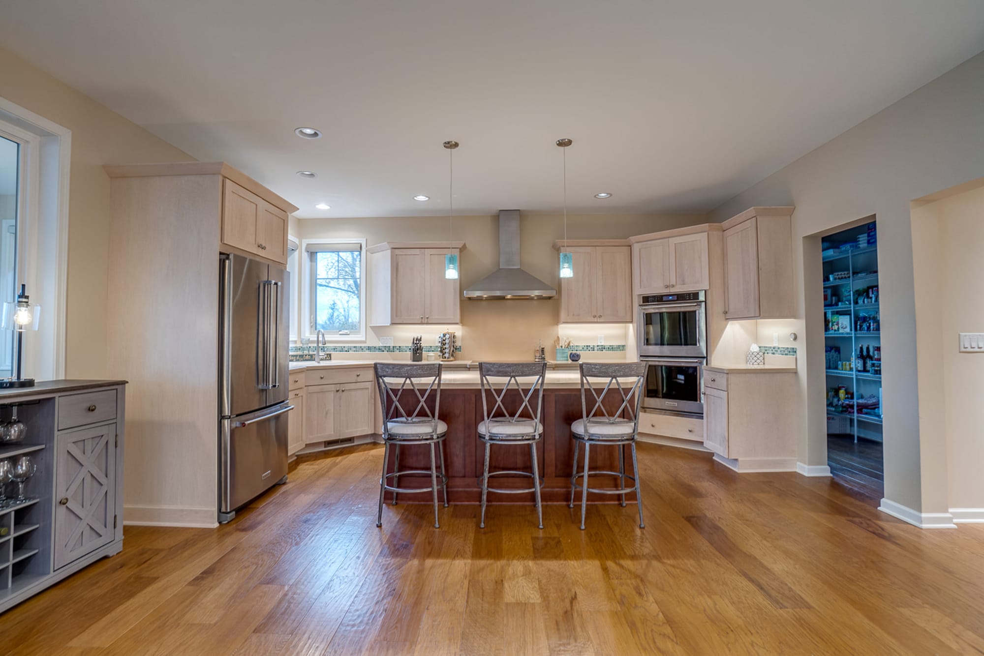 Modern kitchen with island and stools.