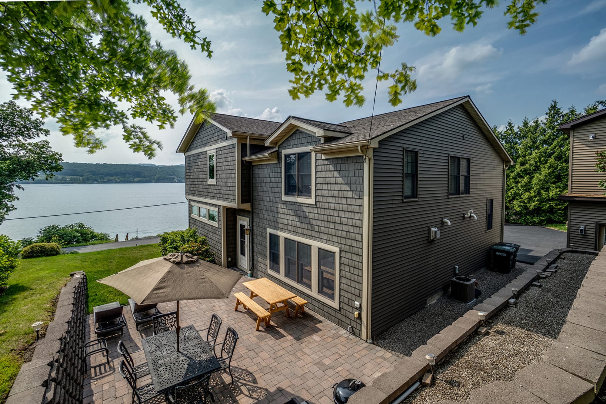 Lakeside house with patio furniture.