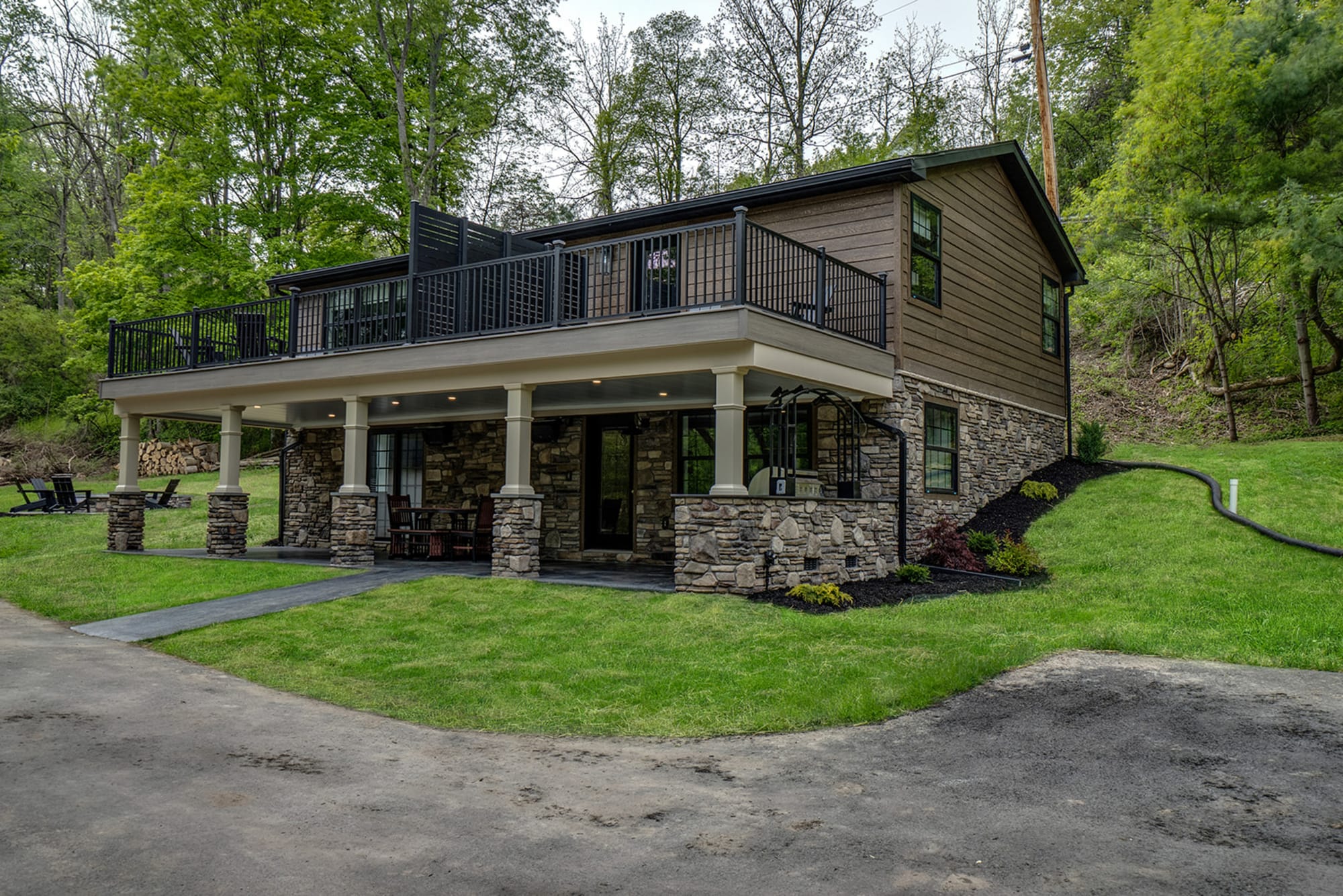 Two-story house with stone facade.