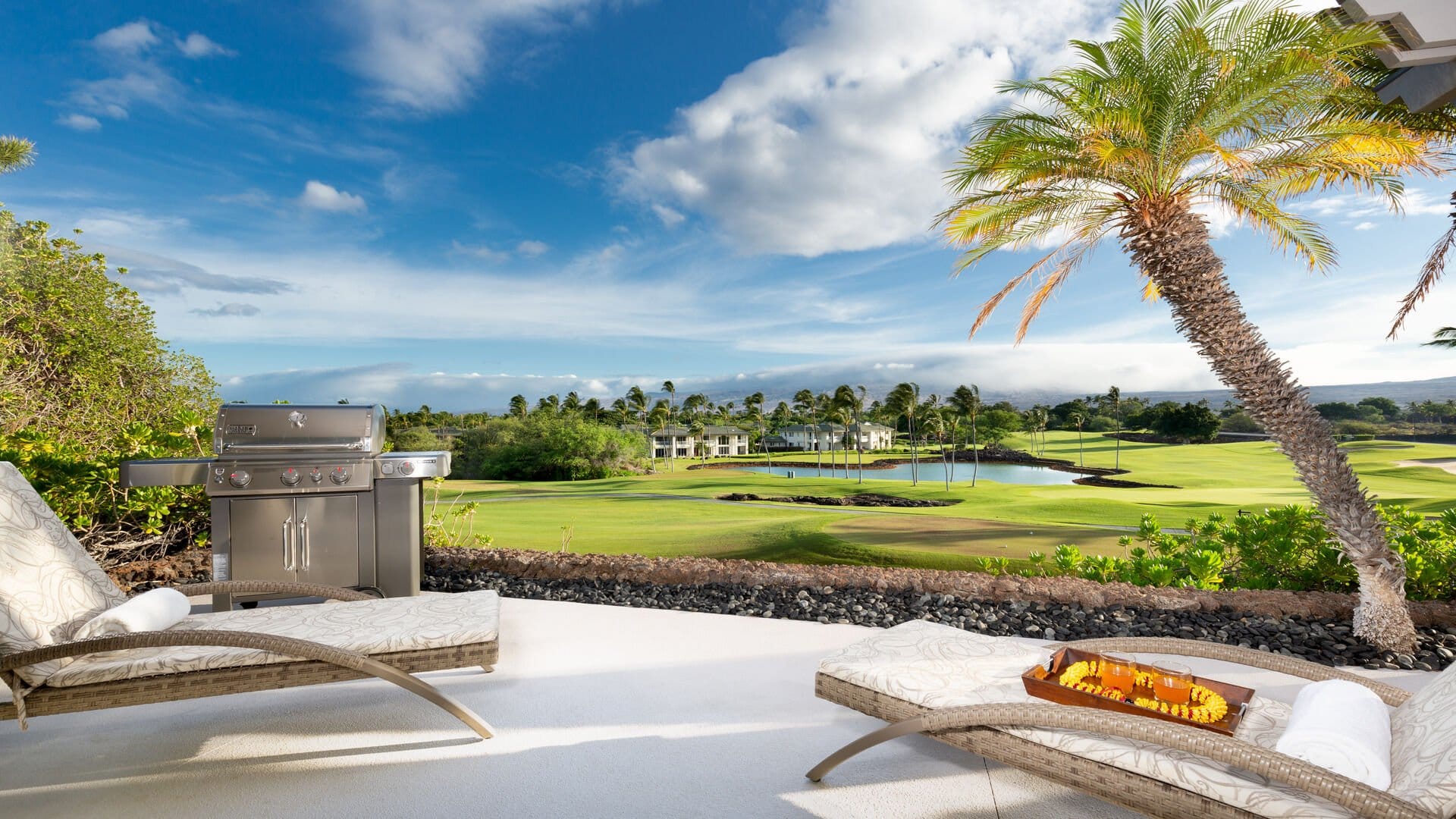 Patio overlooking golf course landscape.