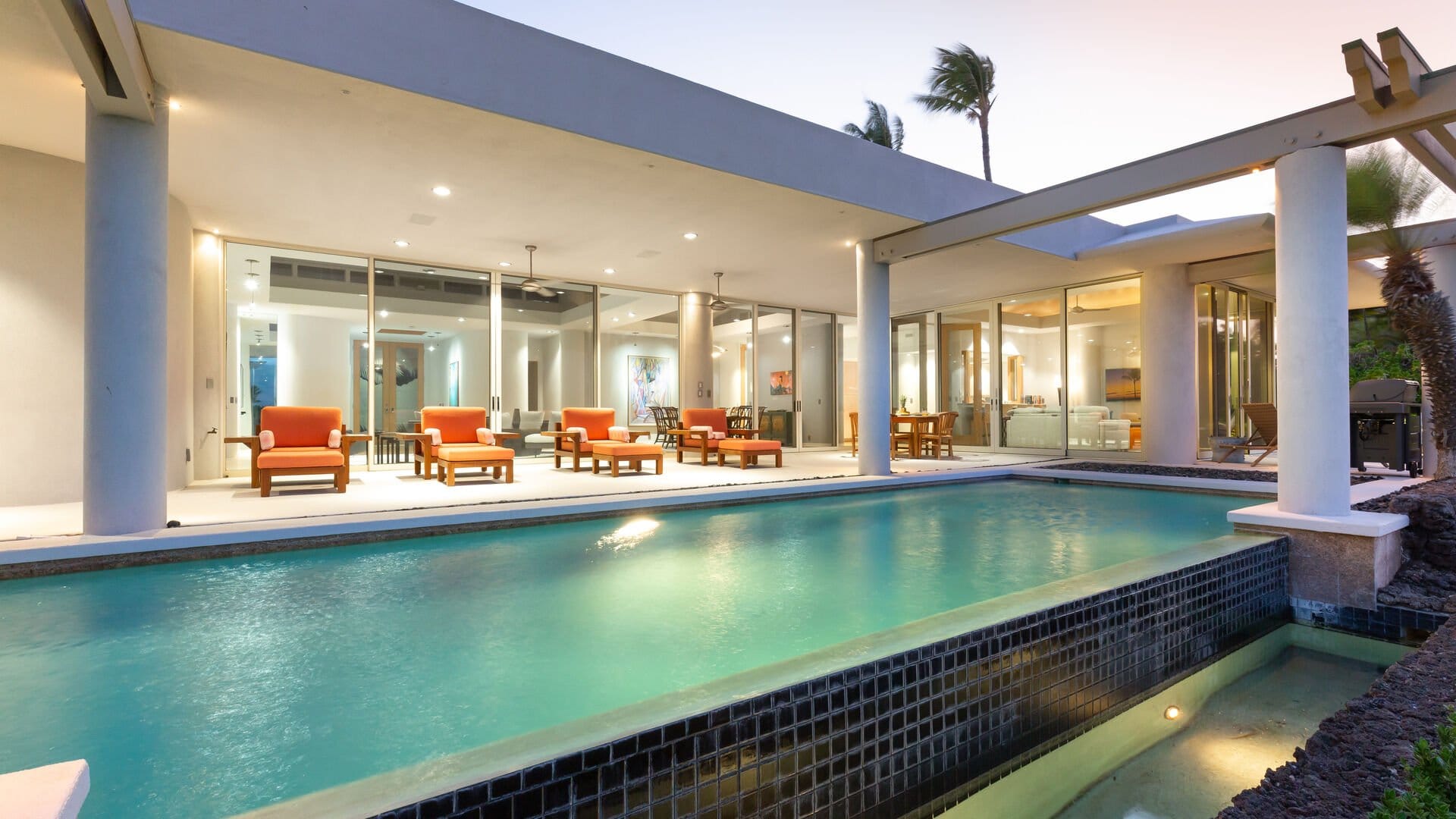 Modern house with pool at dusk.