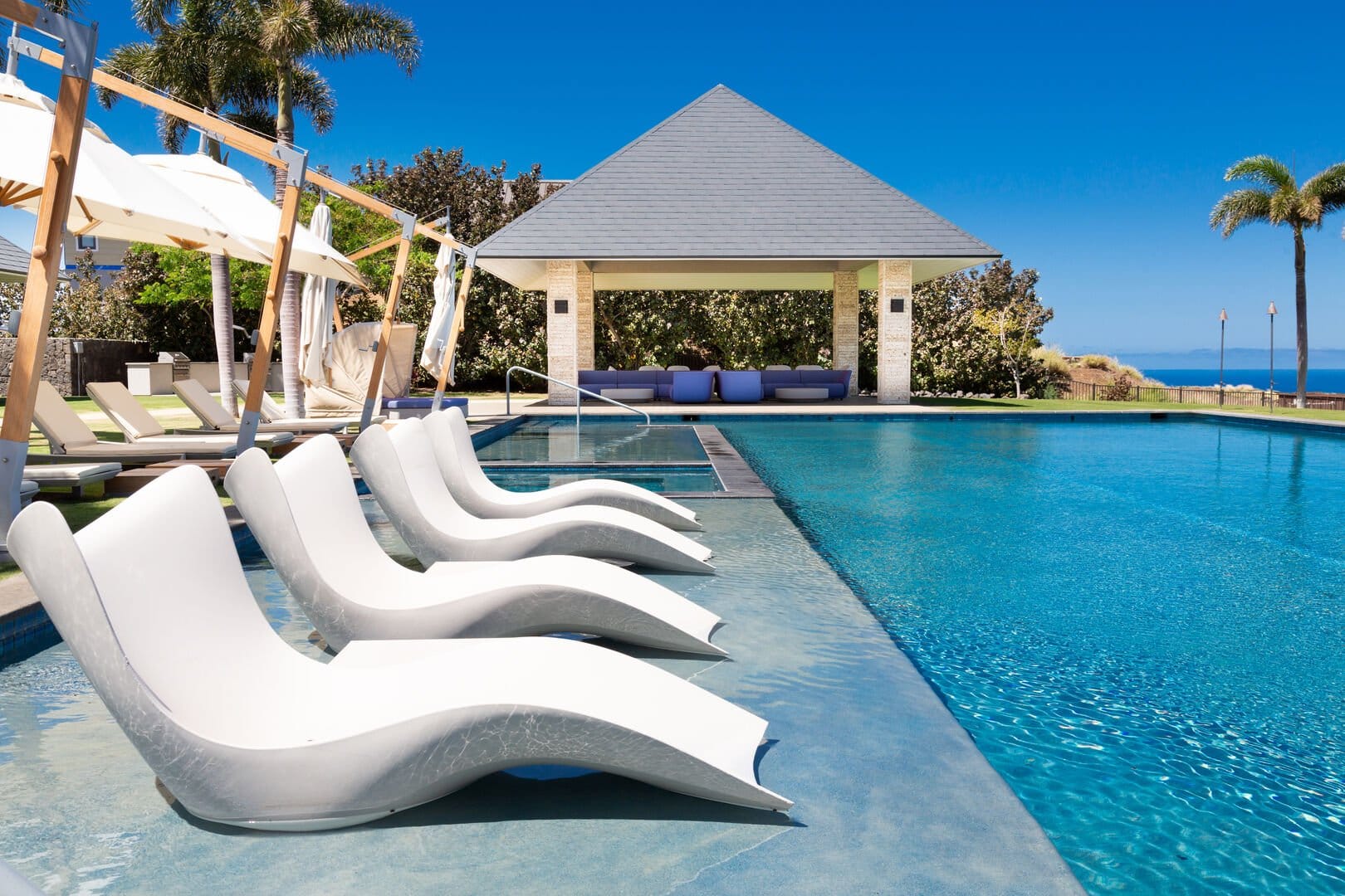 Poolside loungers with ocean view.