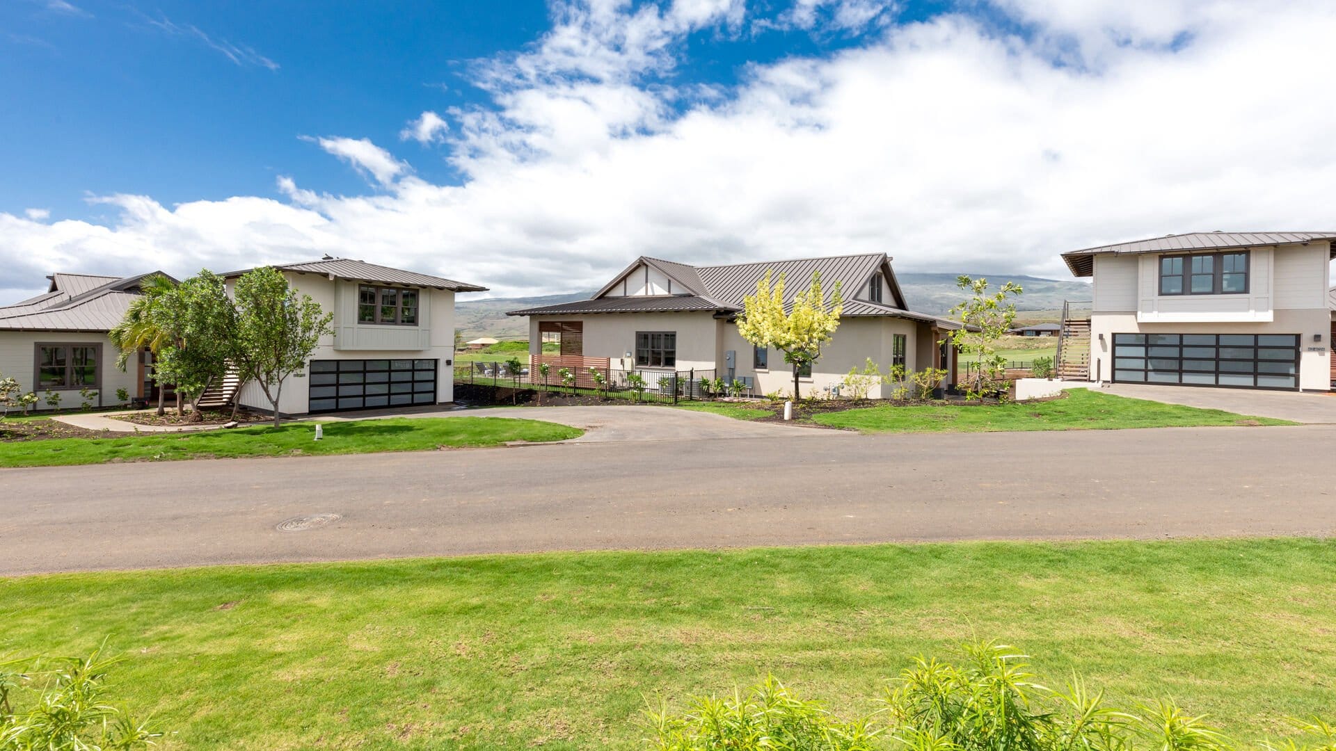 Modern suburban houses under blue sky.