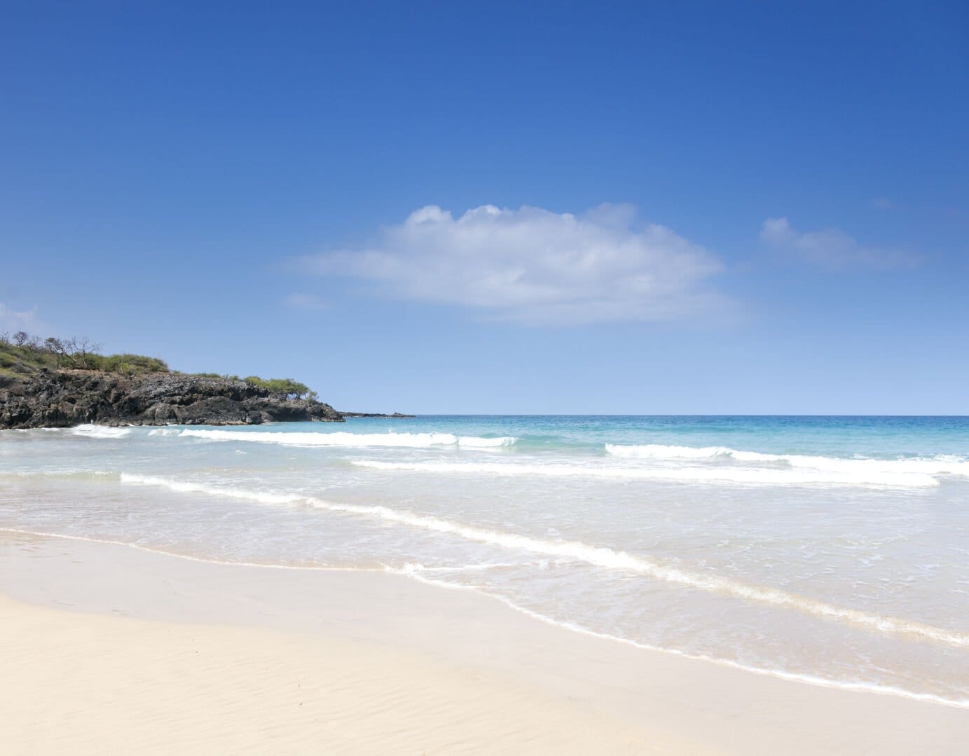 Sandy beach with clear water.