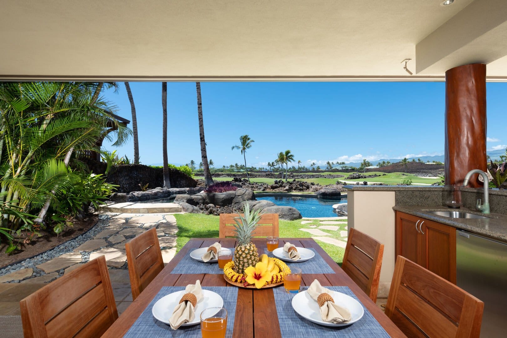 Outdoor dining with tropical view.