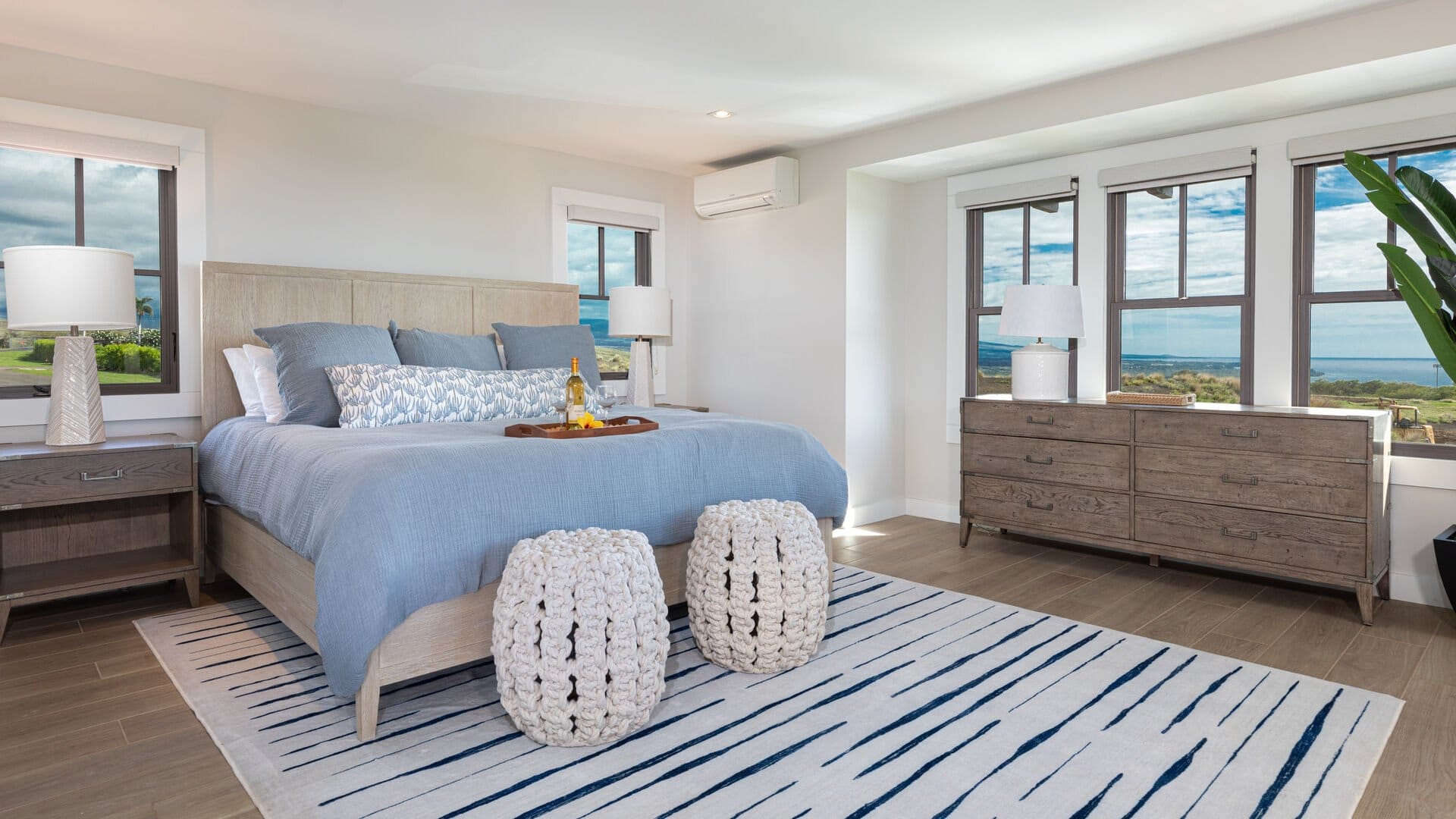 Coastal-themed bedroom with ocean view.