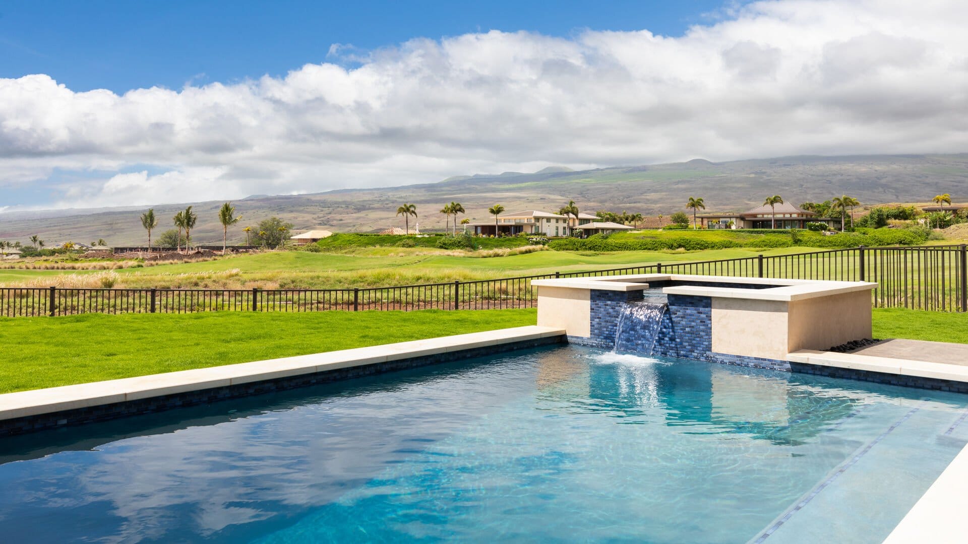 Pool with countryside and mountain view.