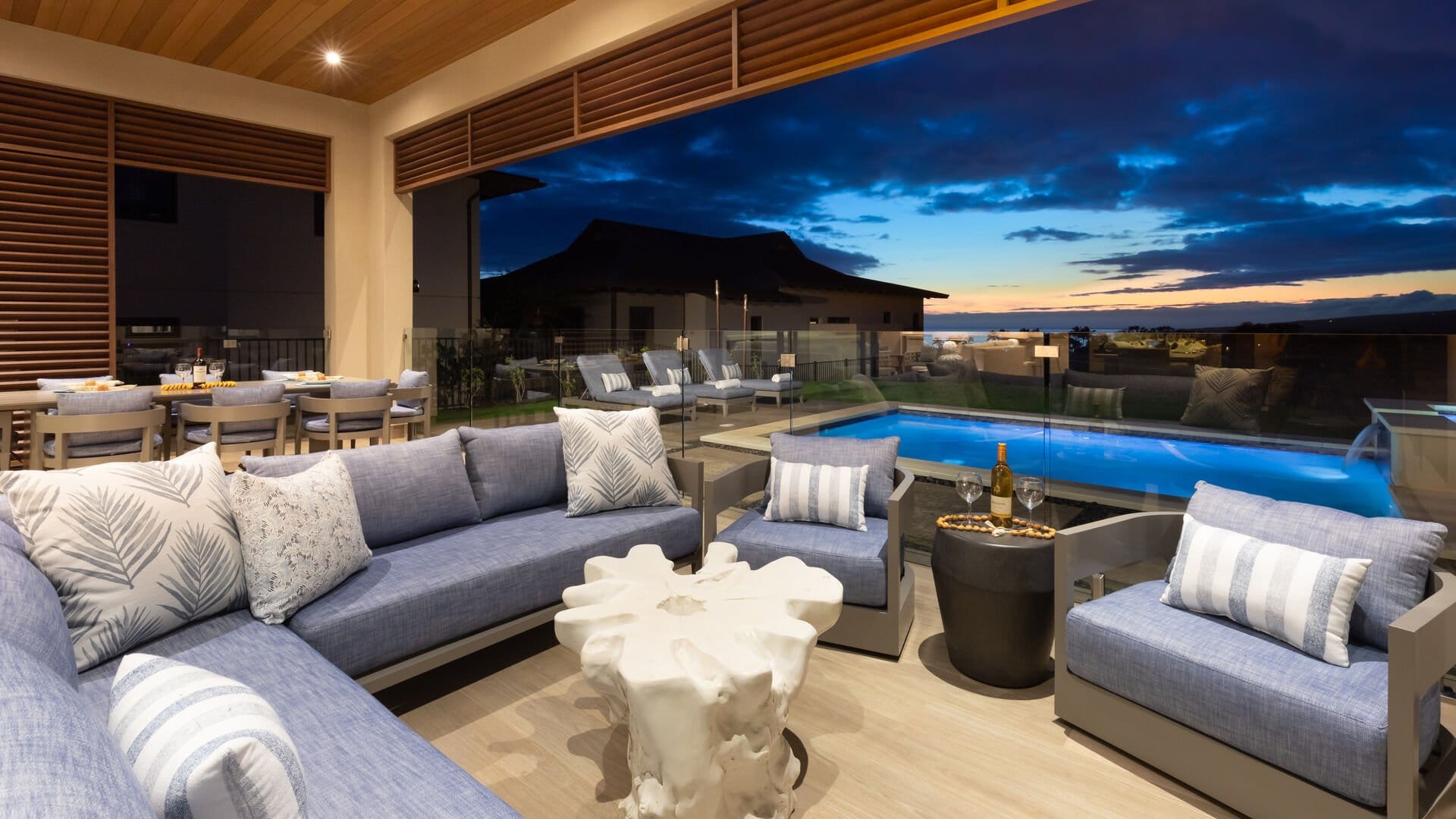 Outdoor patio with pool, sunset view.