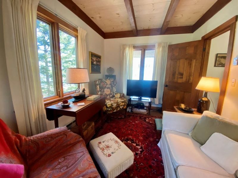 Cozy living room with wooden ceiling.