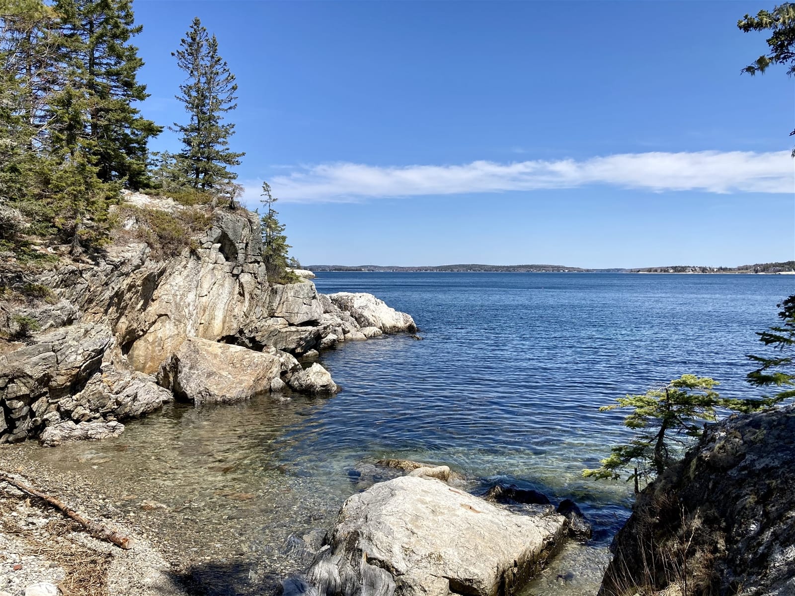 Rocky shoreline with blue water.