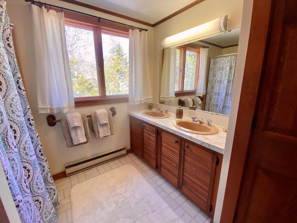 Double-sink bathroom with window.