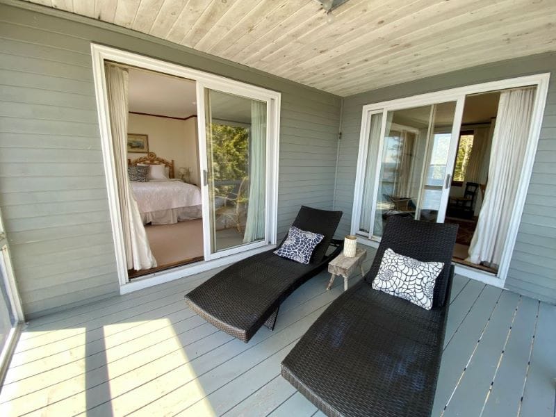 Wooden deck with lounge chairs.