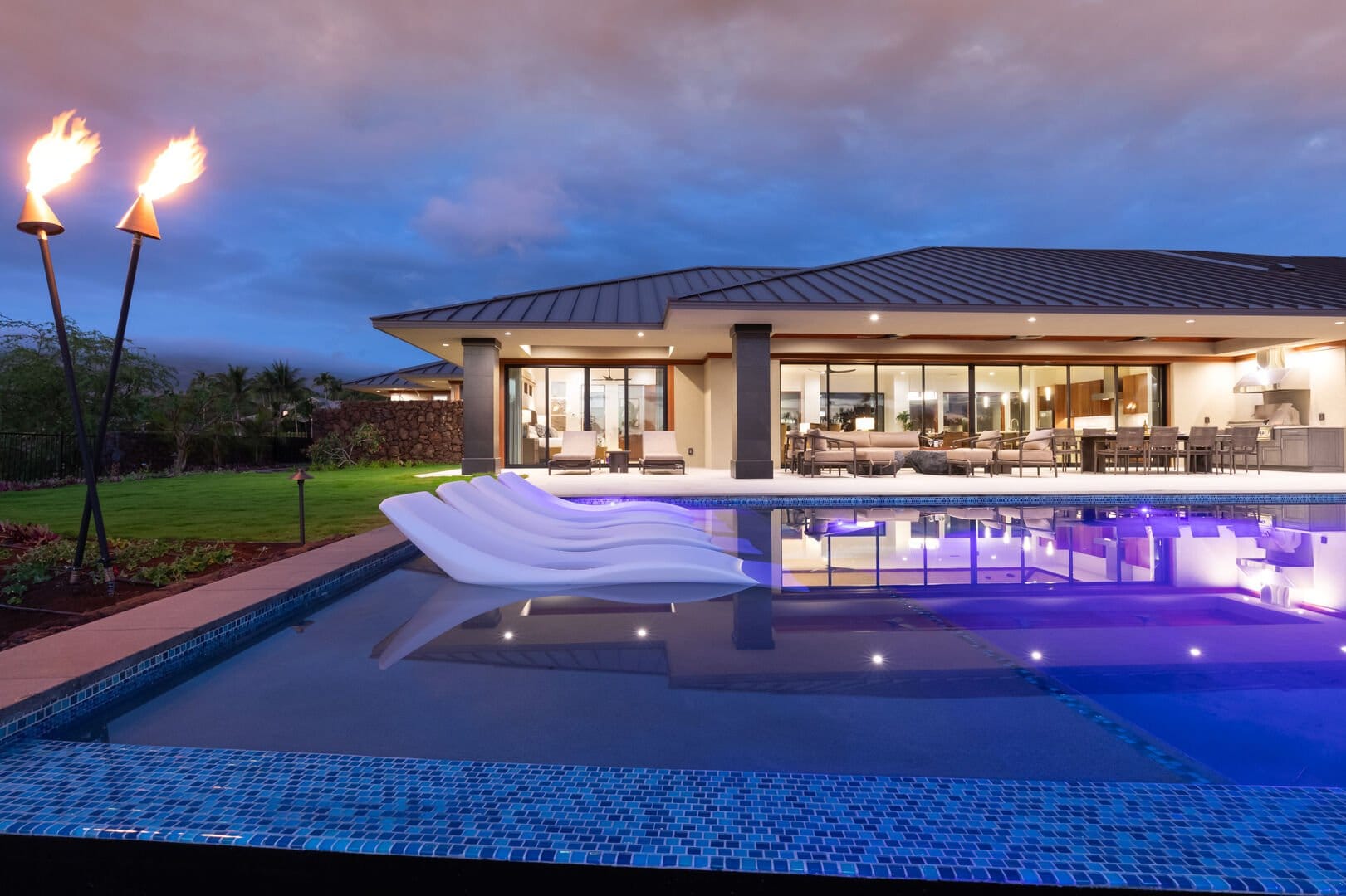 Modern house with pool at dusk.