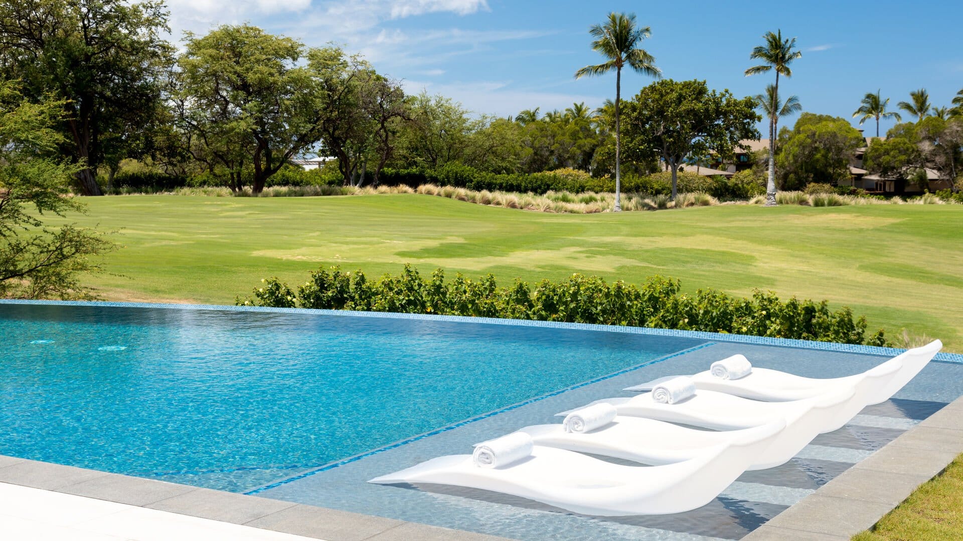 Poolside loungers overlooking golf course