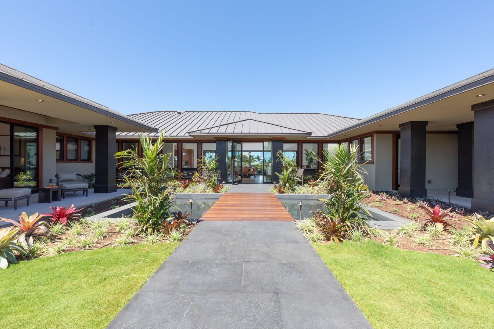 Modern patio with tropical landscaping.