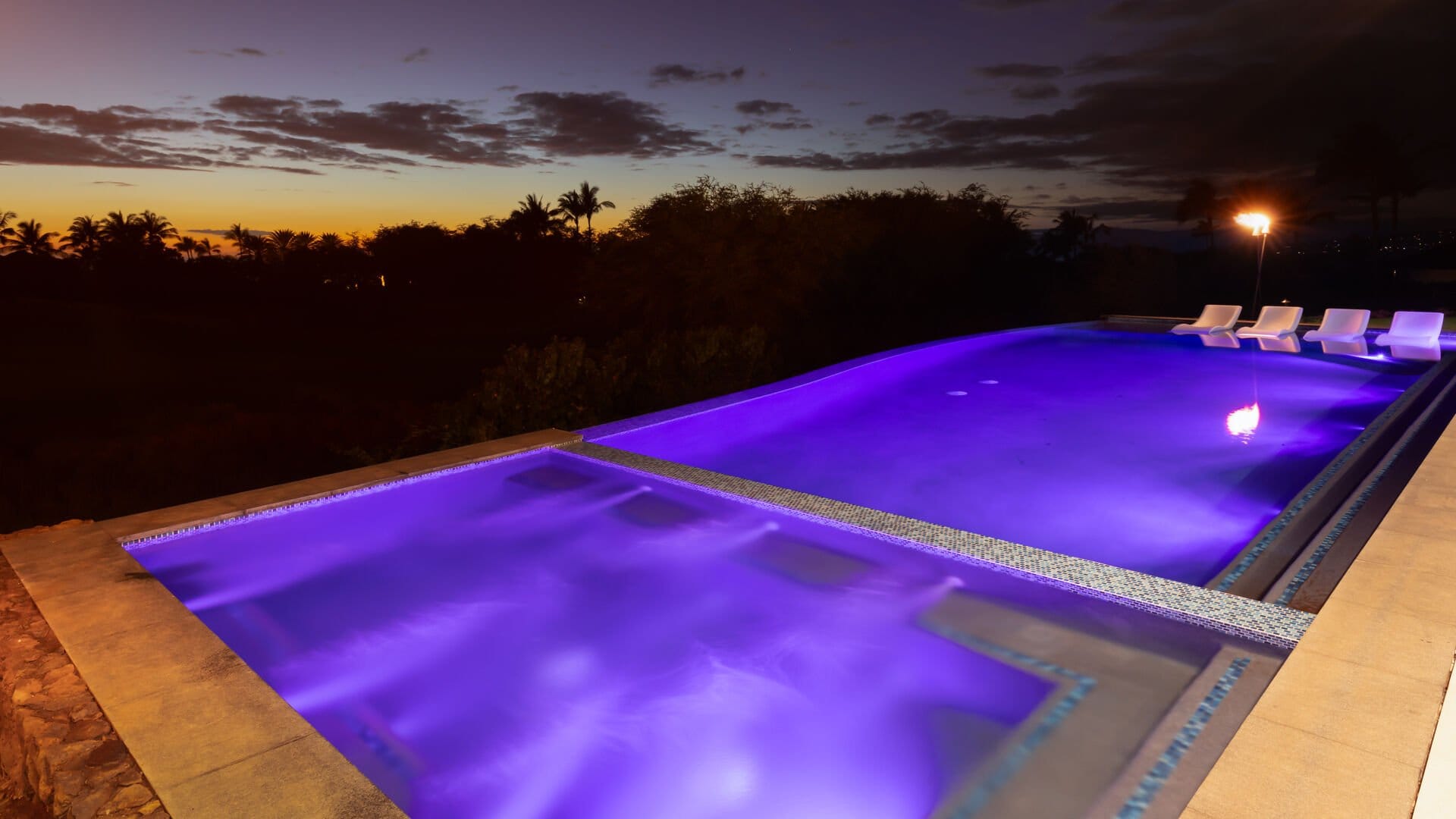 Purple-lit pool at sunset.