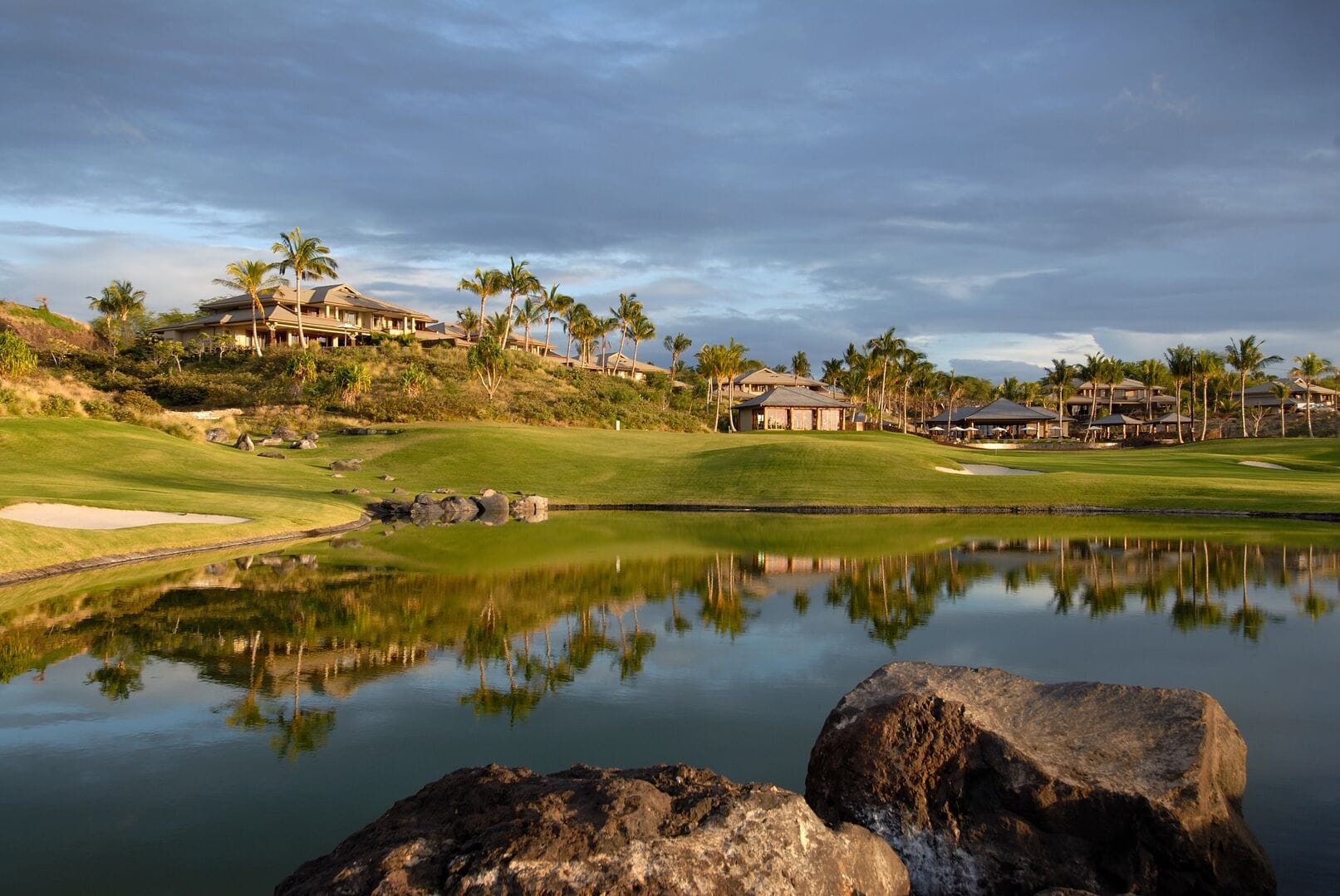 Tropical resort overlooking serene water.