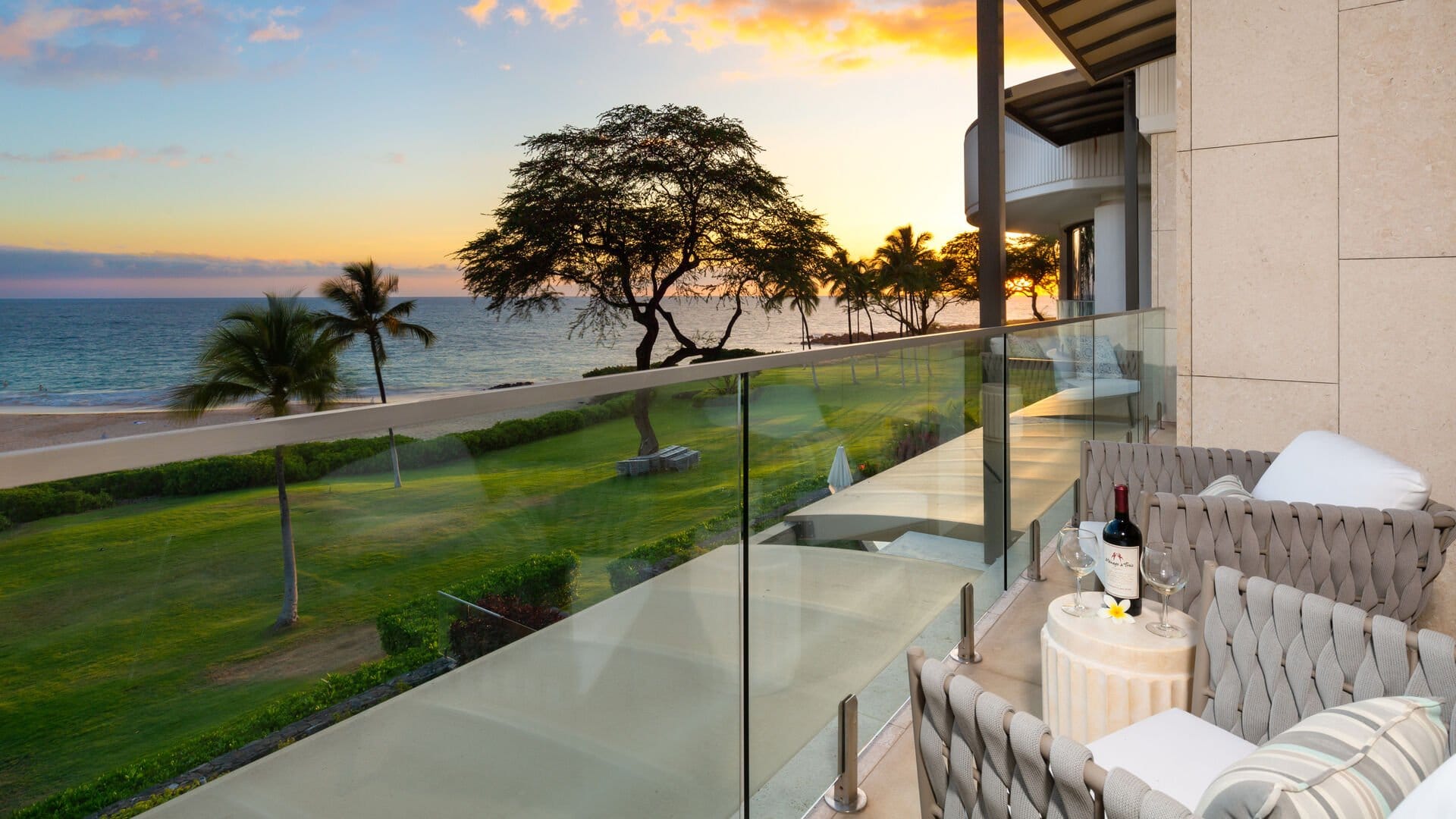 Oceanfront balcony at sunset, wine.