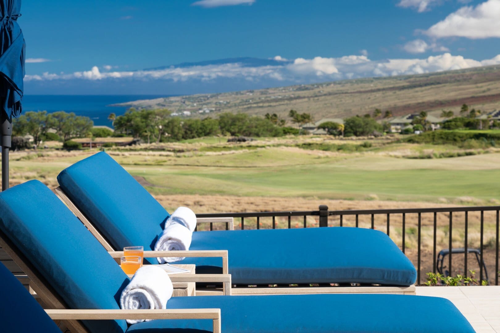 Lounge chairs overlooking scenic landscape.