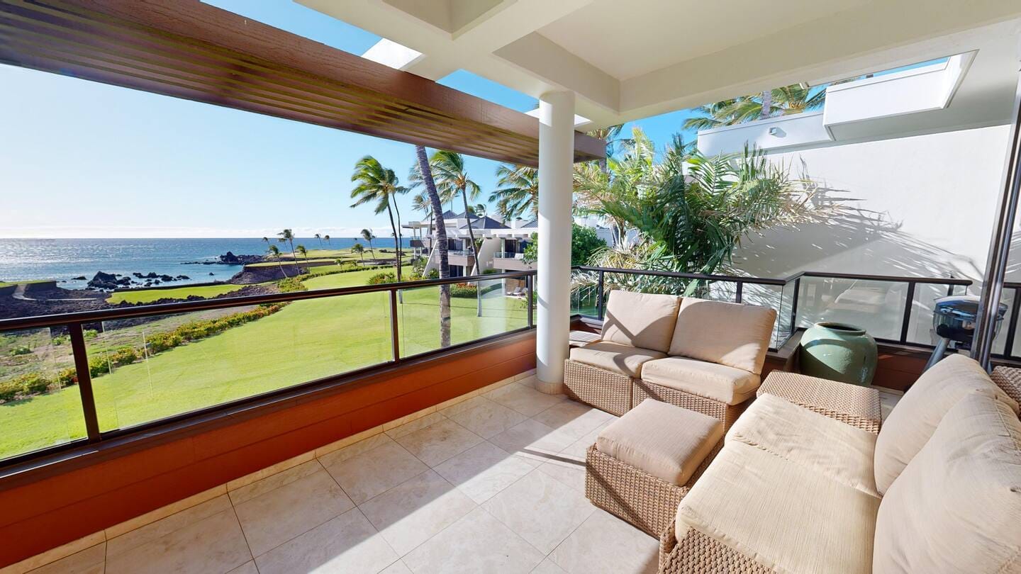 Ocean-view balcony with outdoor couches.