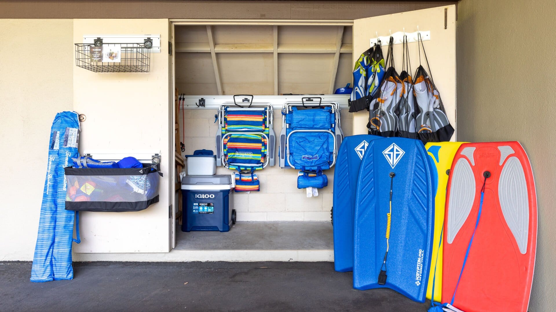 Beach gear organized in storage closet.