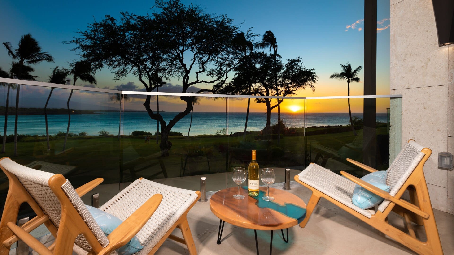 Ocean sunset view from patio chairs.