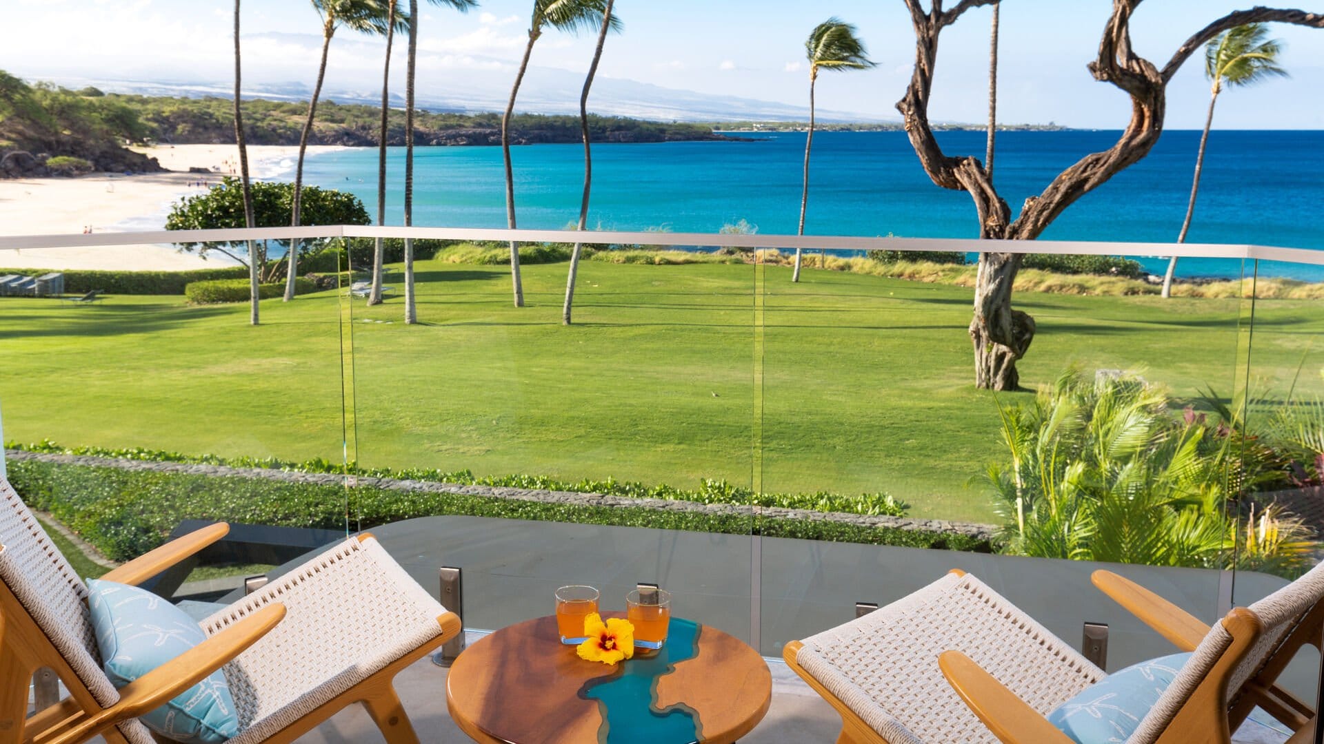 Beach view from balcony with drinks.