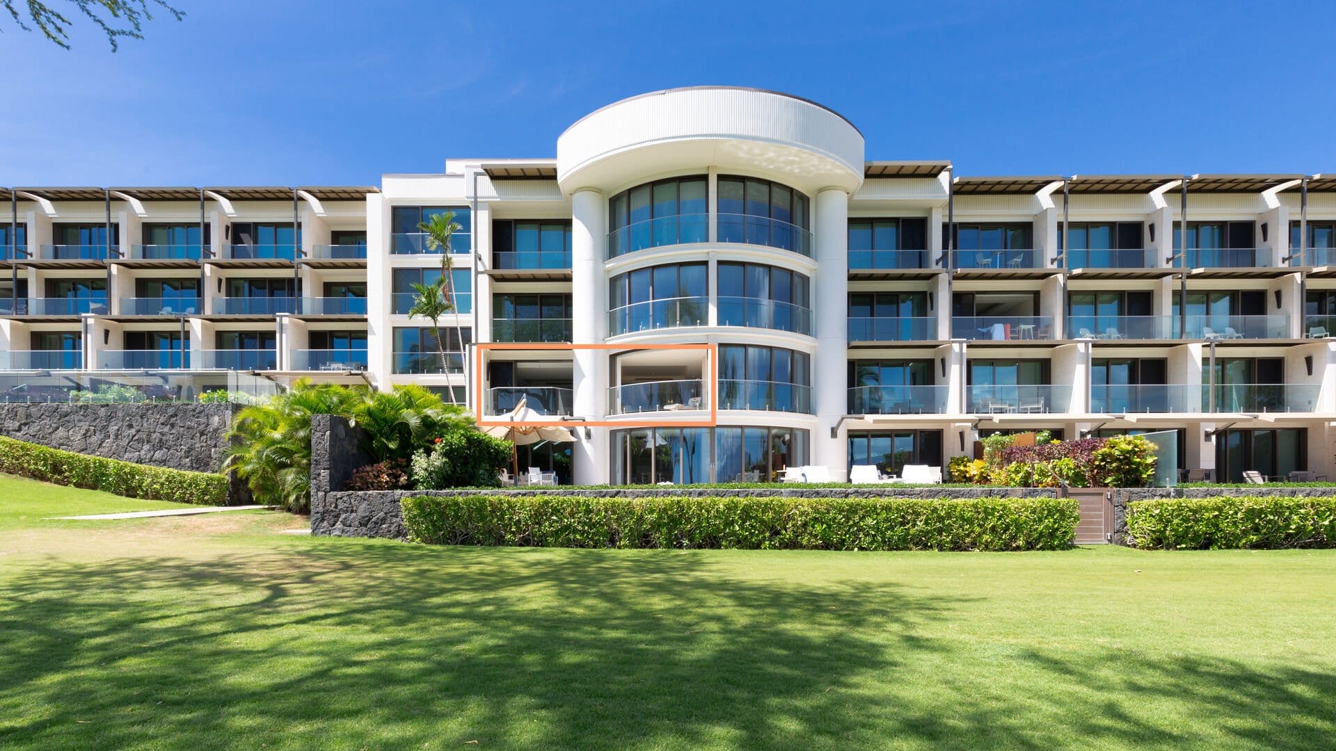 Modern beachfront hotel with balconies.