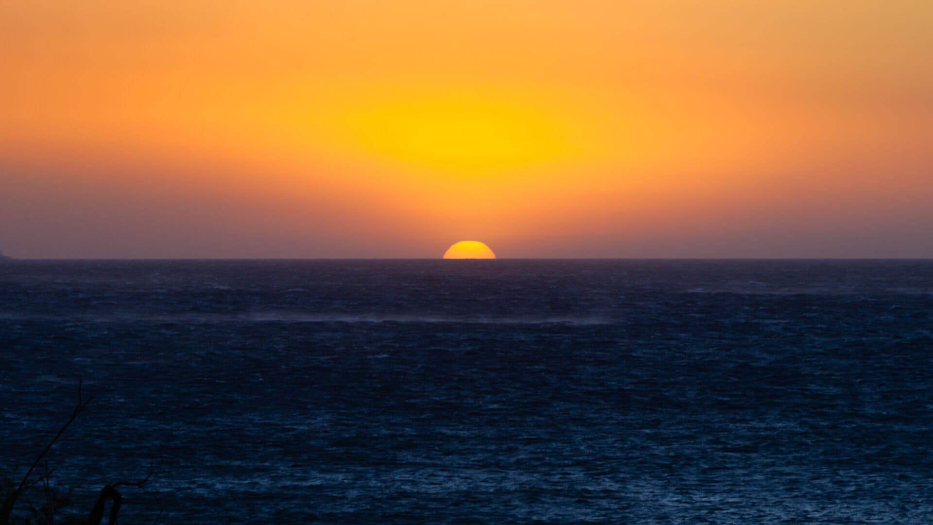 Sun setting over the ocean.