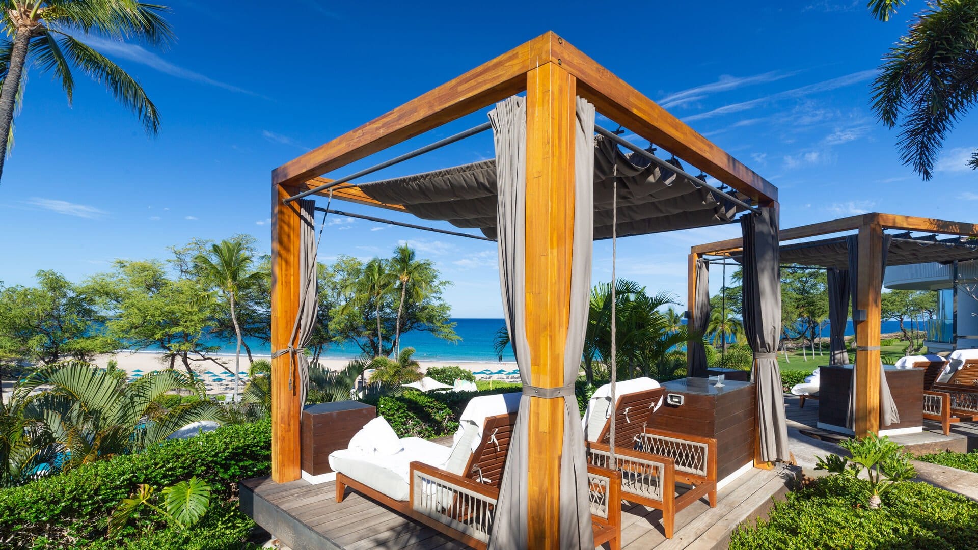 Beach cabanas overlooking tropical ocean.