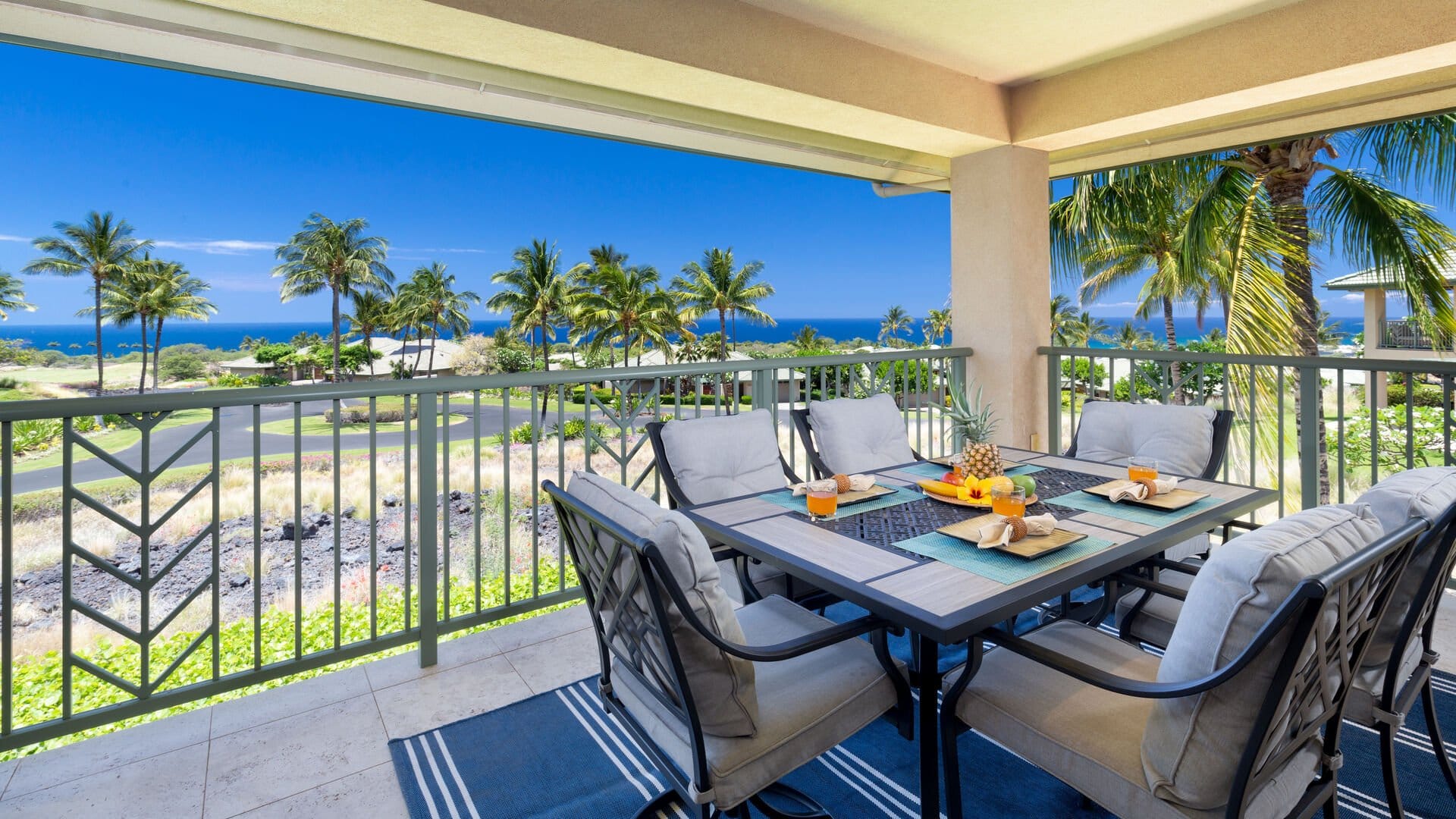 Balcony with ocean and palm trees.