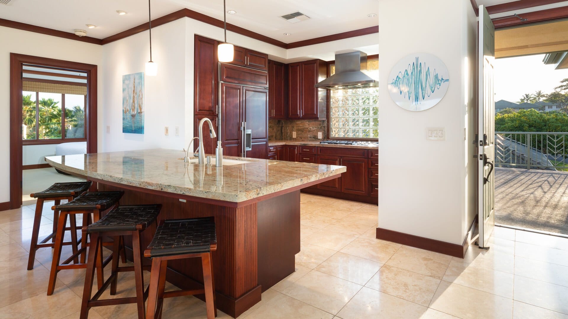 Modern kitchen with island and stools.