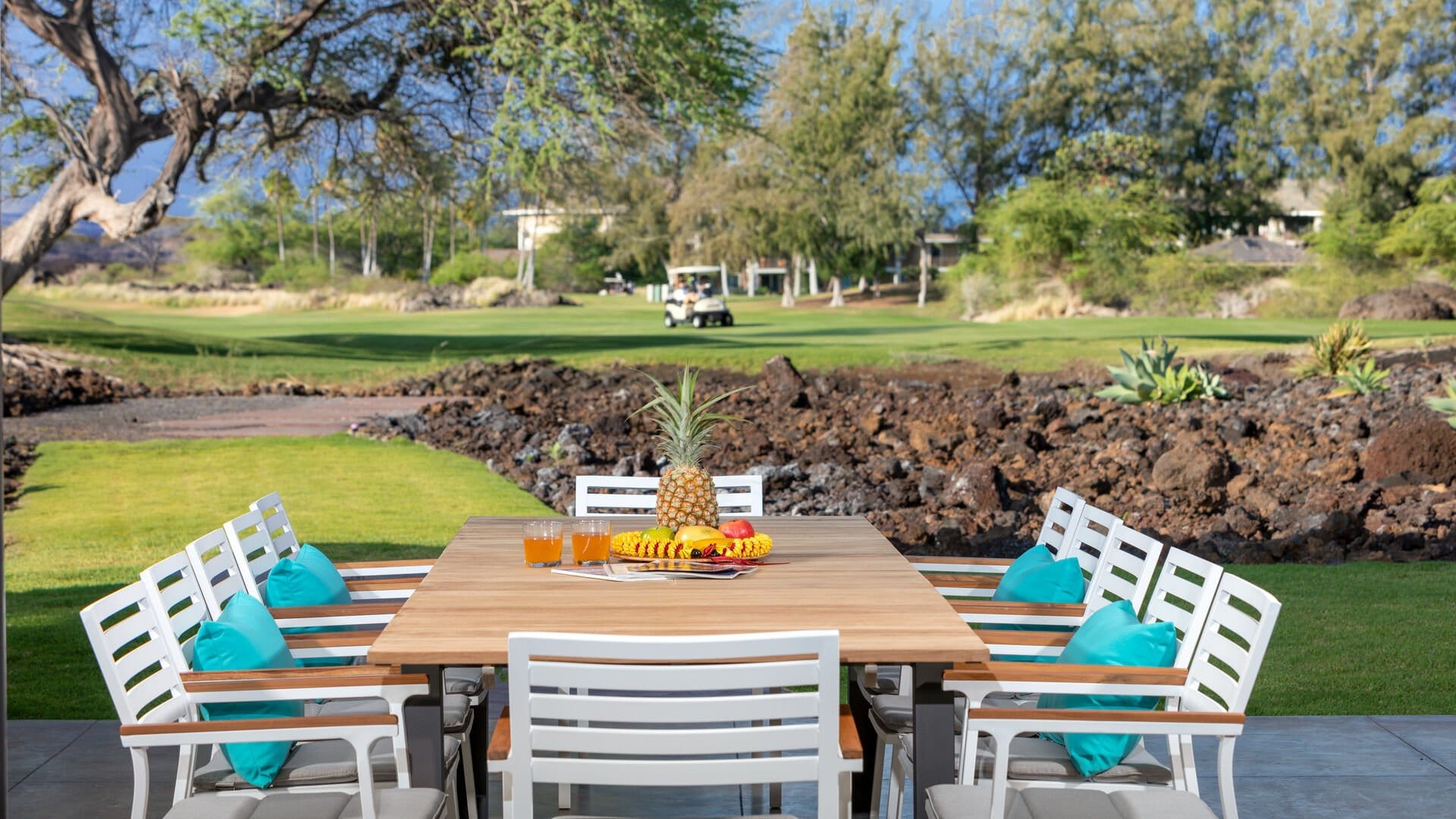 Outdoor dining table with fruit centerpiece.