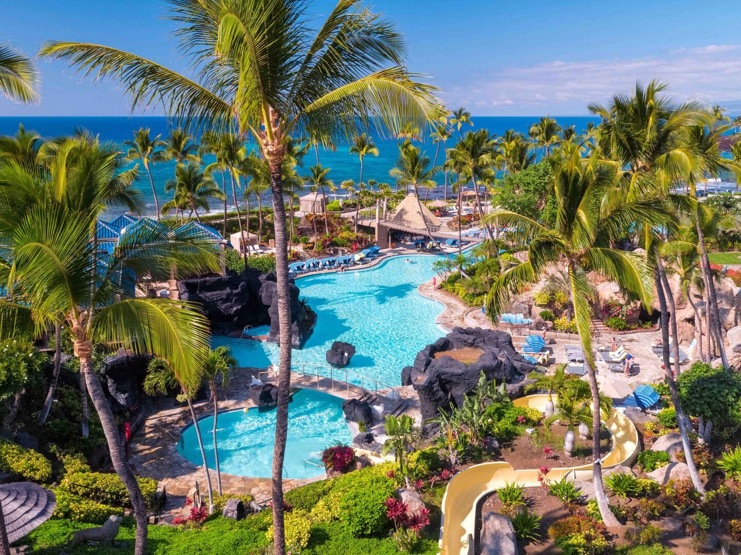 Tropical resort with pools and palm trees.