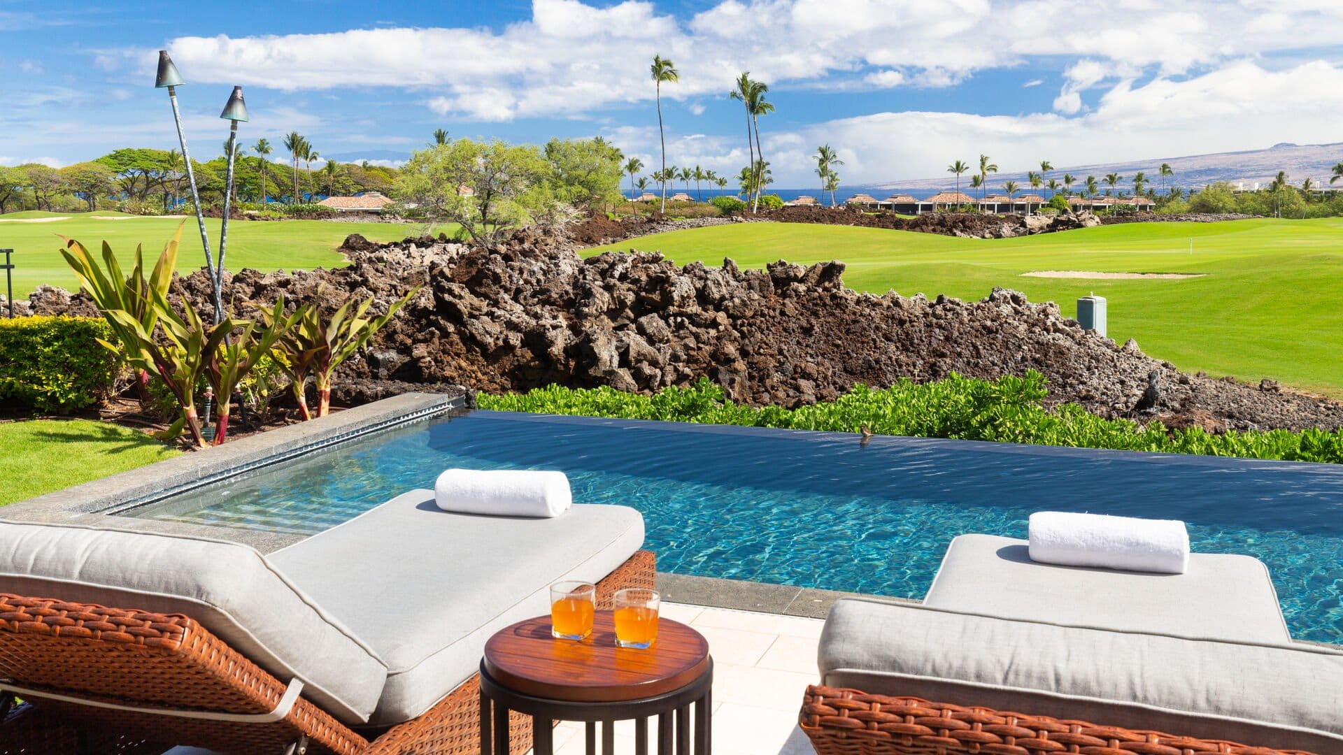 Poolside loungers with scenic view.