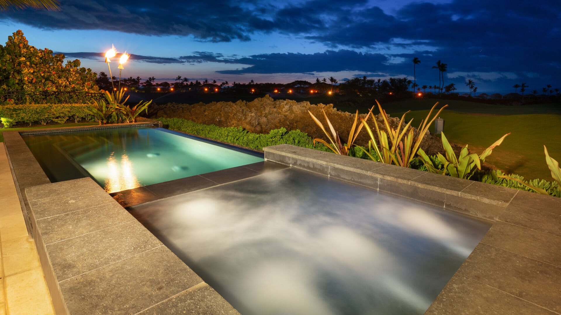 Luxurious pool with evening lights.