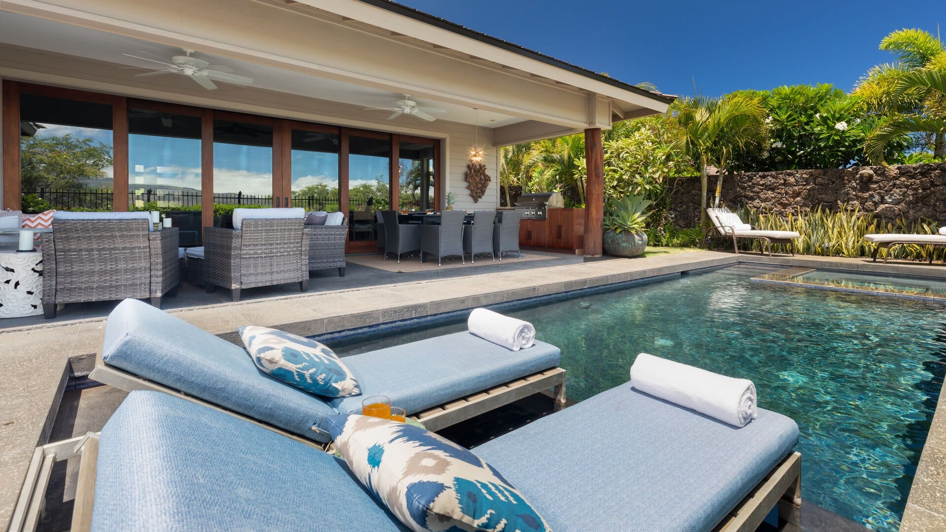 Poolside loungers and outdoor seating area.