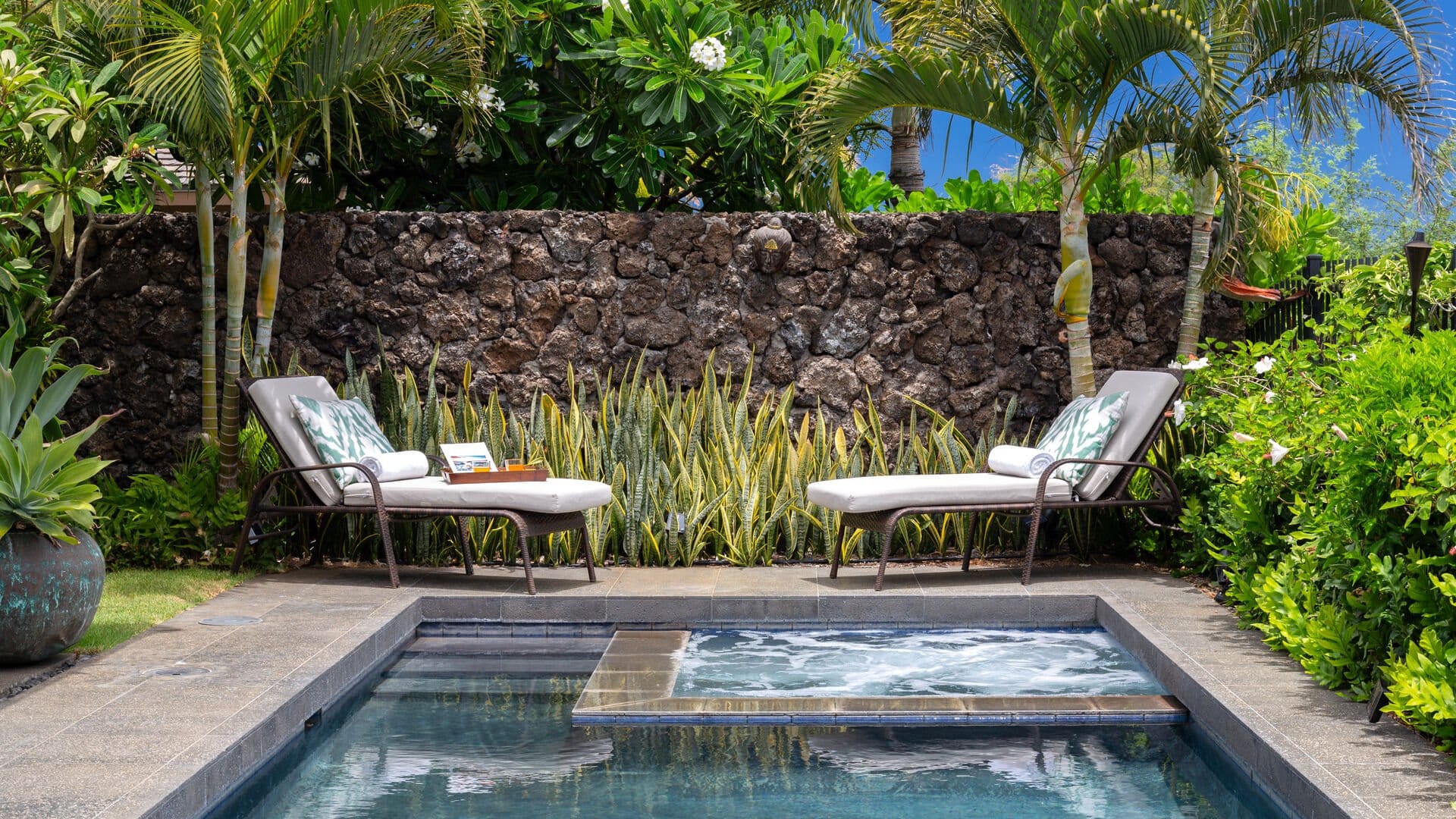 Tropical poolside chairs and plants.