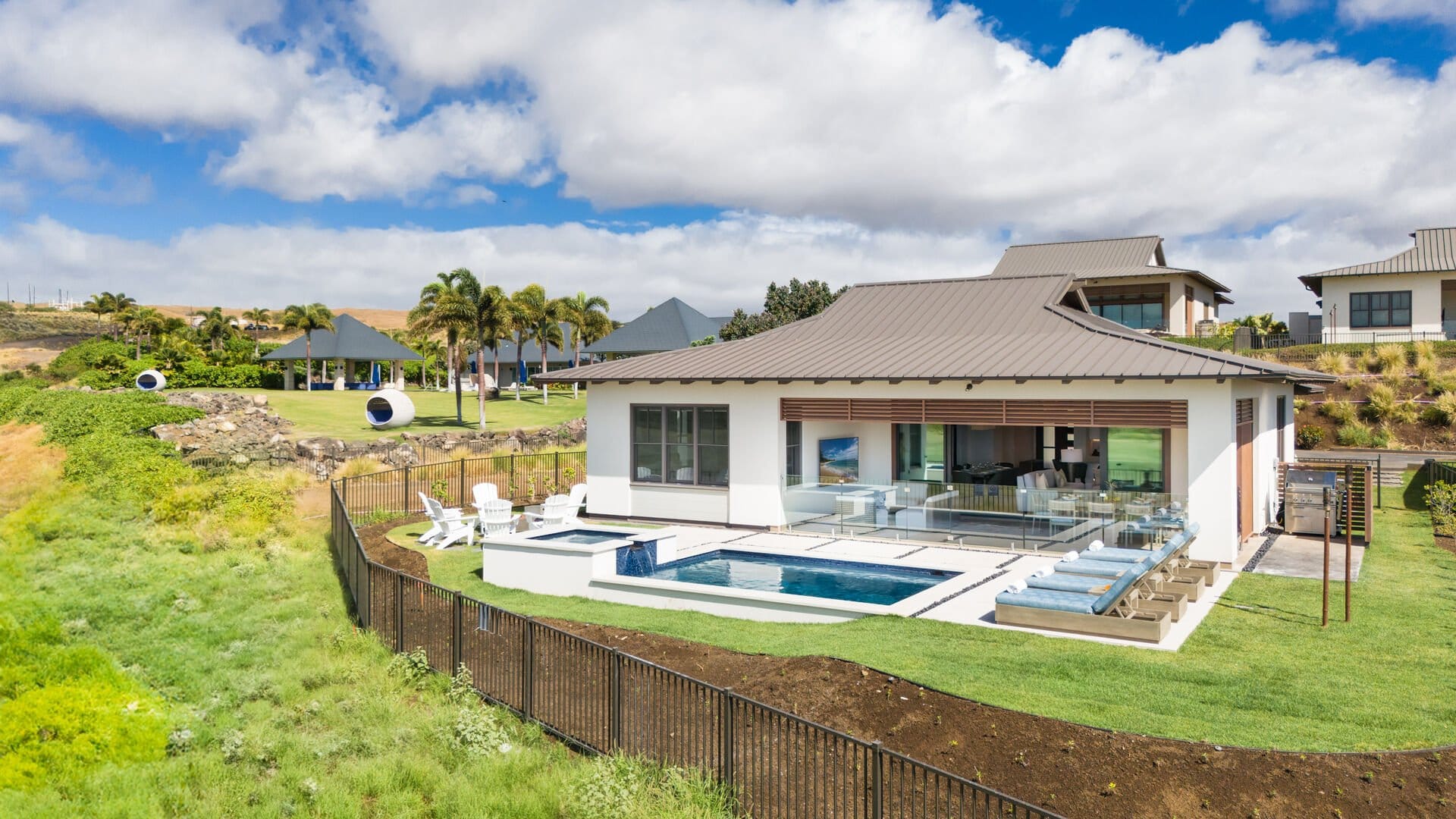 Modern house with pool and lawn.