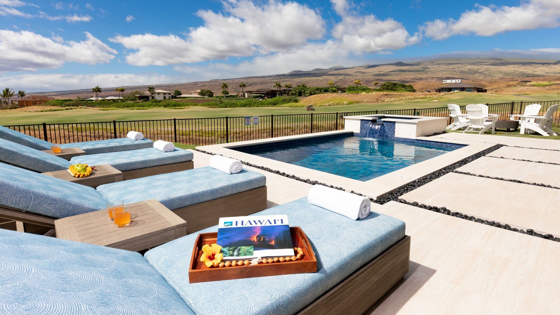 Poolside loungers with scenic view.