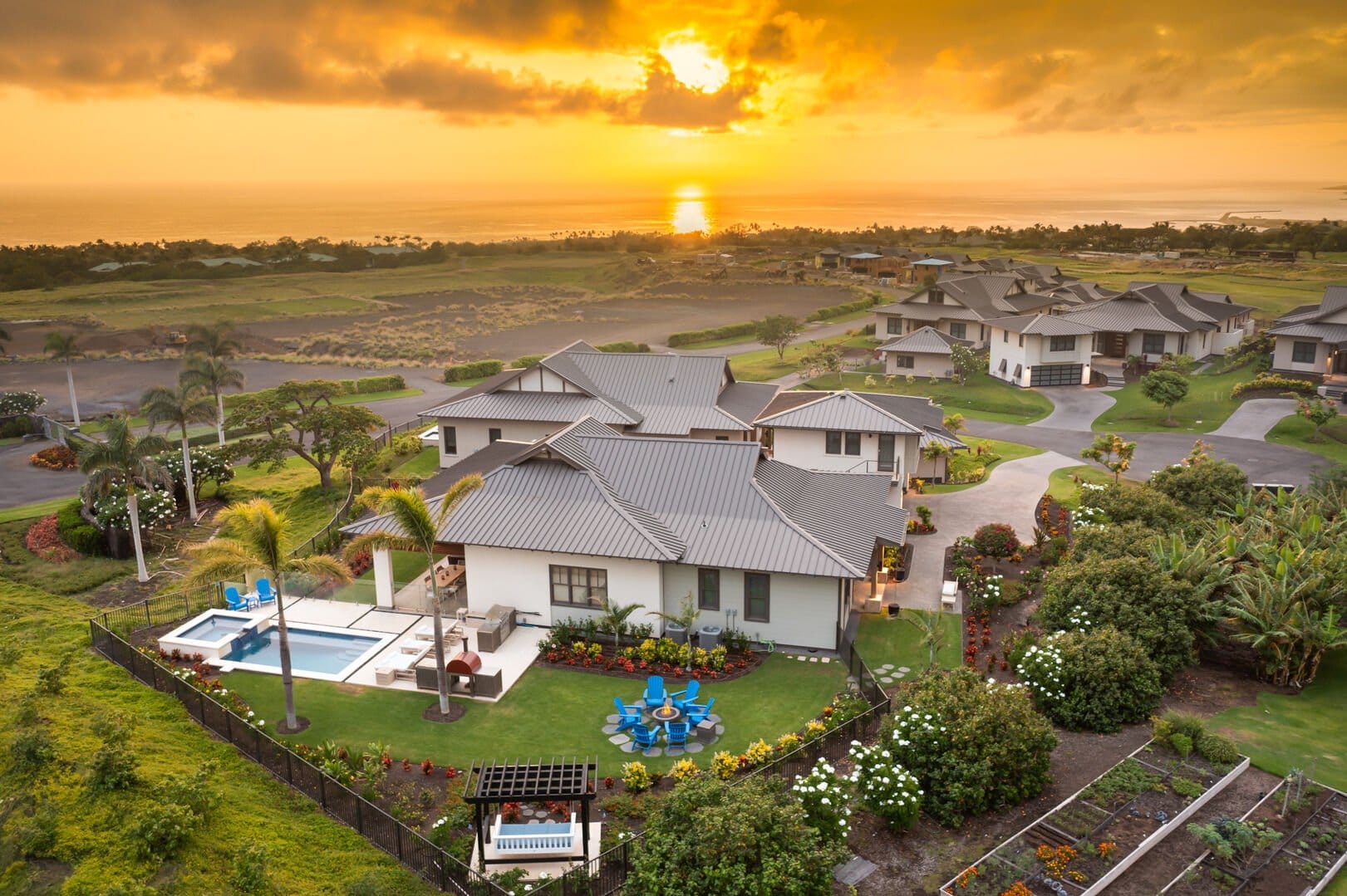 Oceanview house at sunset with pool.